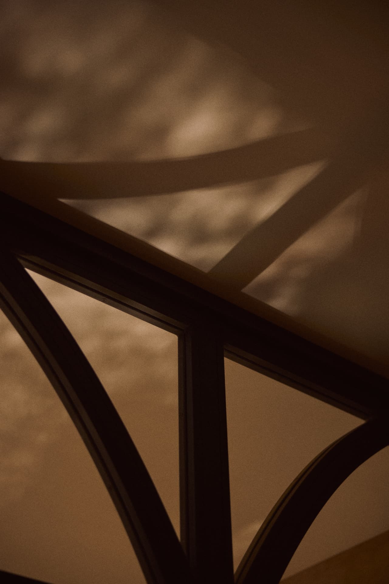 Soft shadow of a Moorish arch on a warm plaster wall