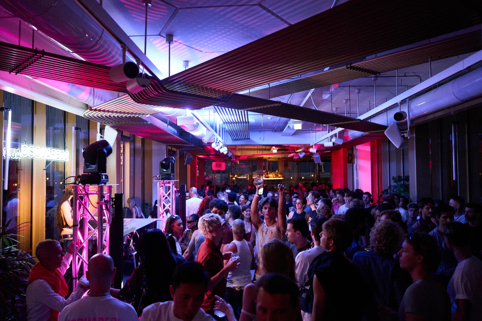 The venue in full swing under pink and blue light