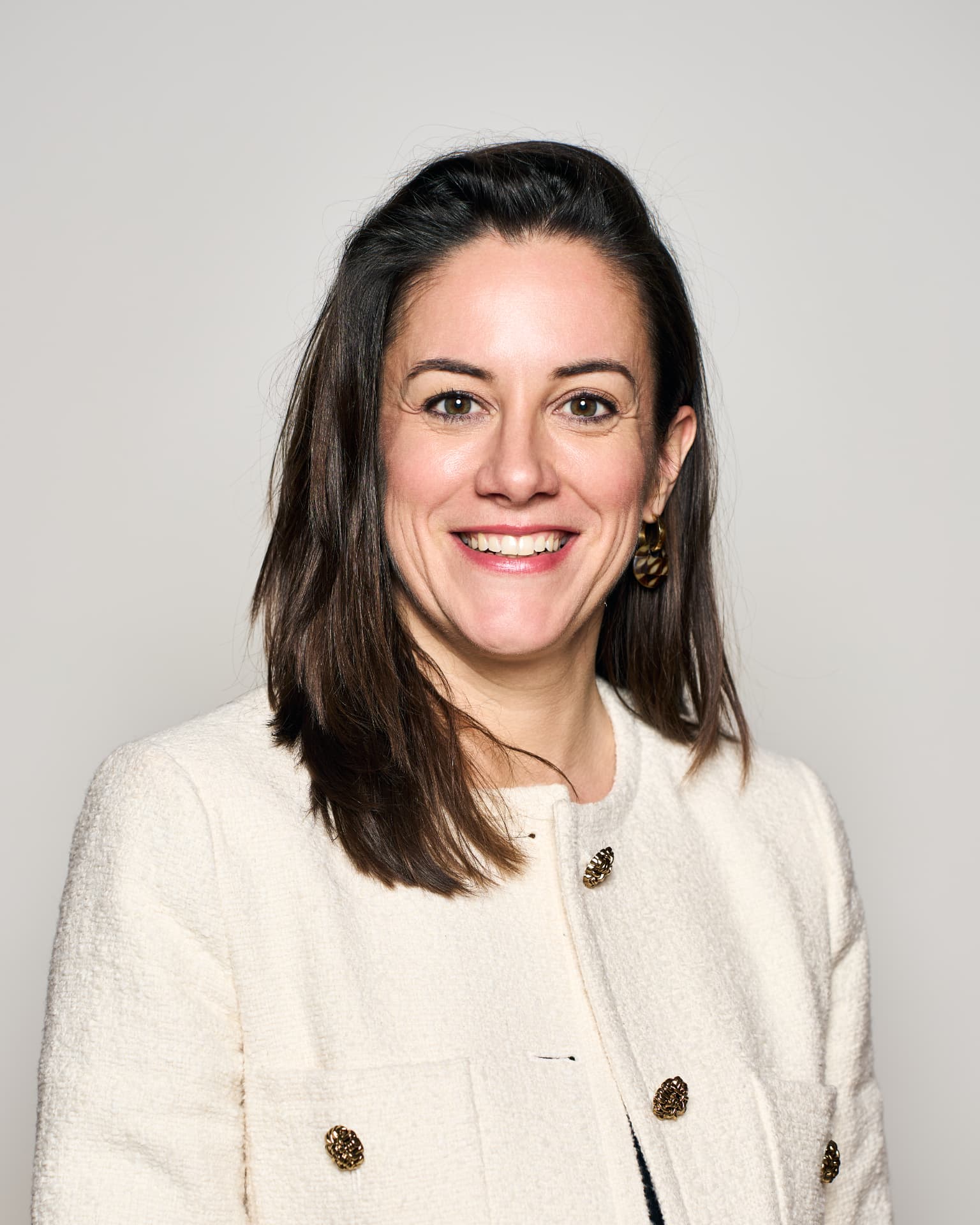 Zakelijk studioportret van een vrouw in een lichte blazer