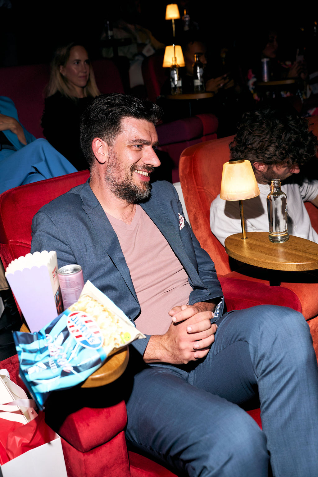 Director David Cocheret smiling in a red cinema chair with popcorn