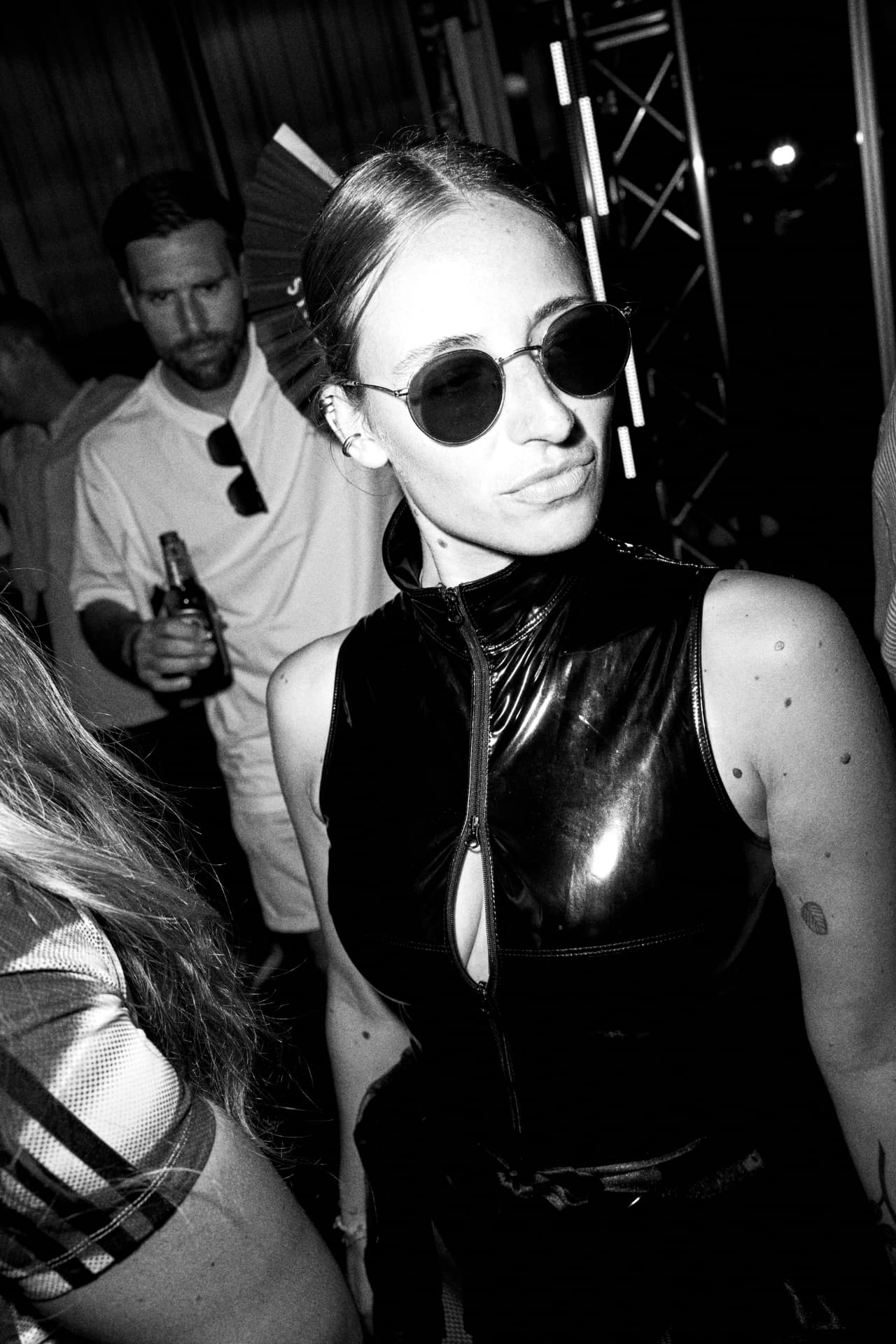 Black and white portrait of a guest in latex and sunglasses