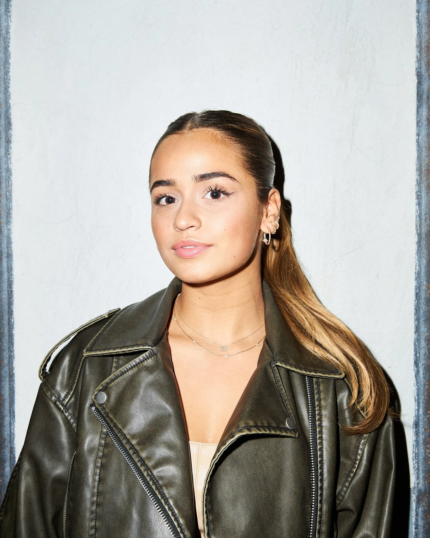 Portrait of Noa in an oversized leather jacket