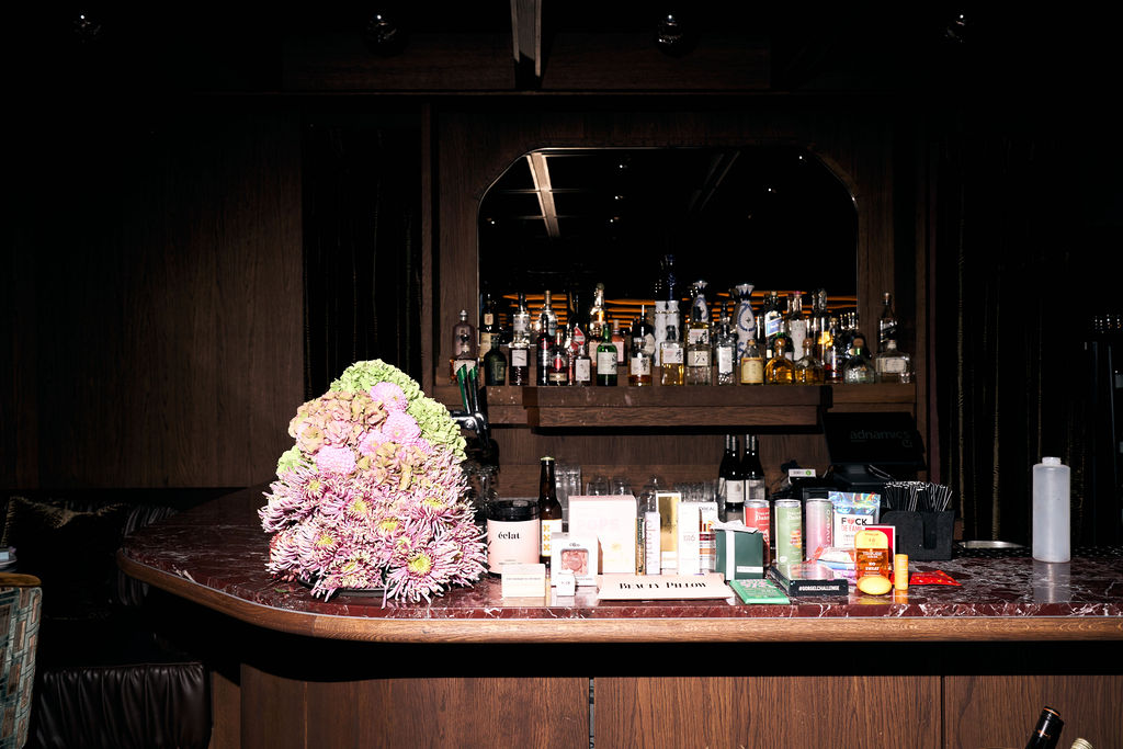 Flower arrangement and gifting table on the bar at Rotate before the guests arrive