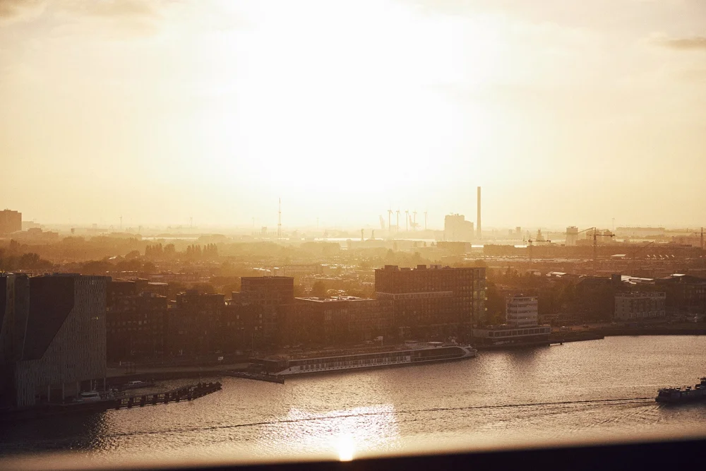 Amsterdam Noord and the IJ in golden haze from above