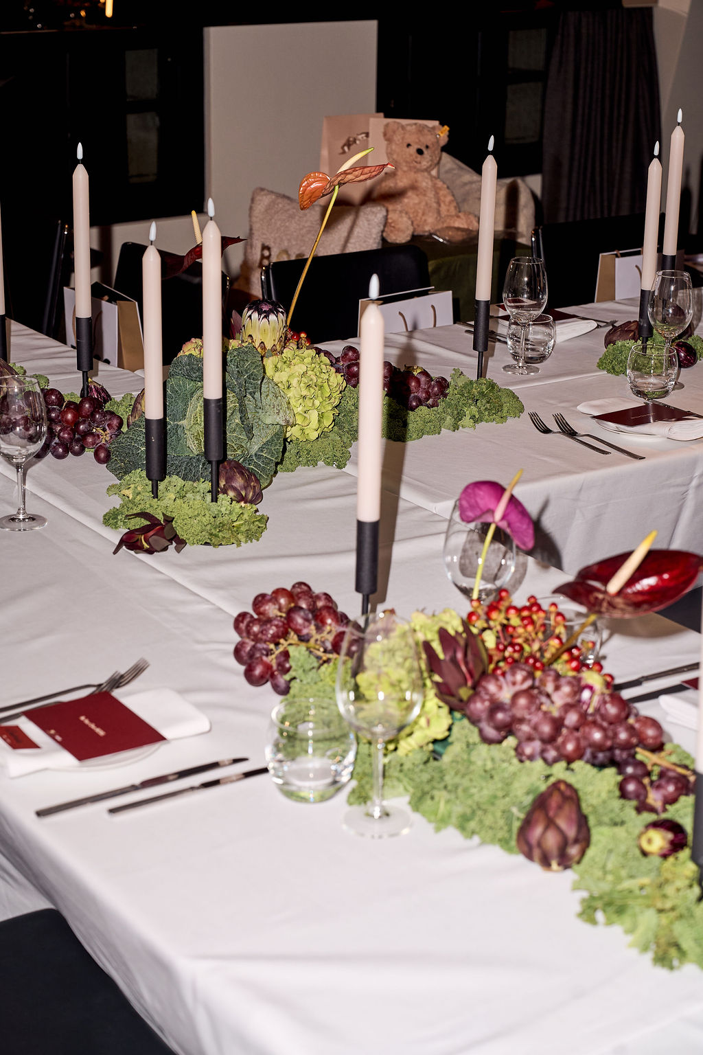 Long candlelit dinner table set for the BOSS Connectors dinner