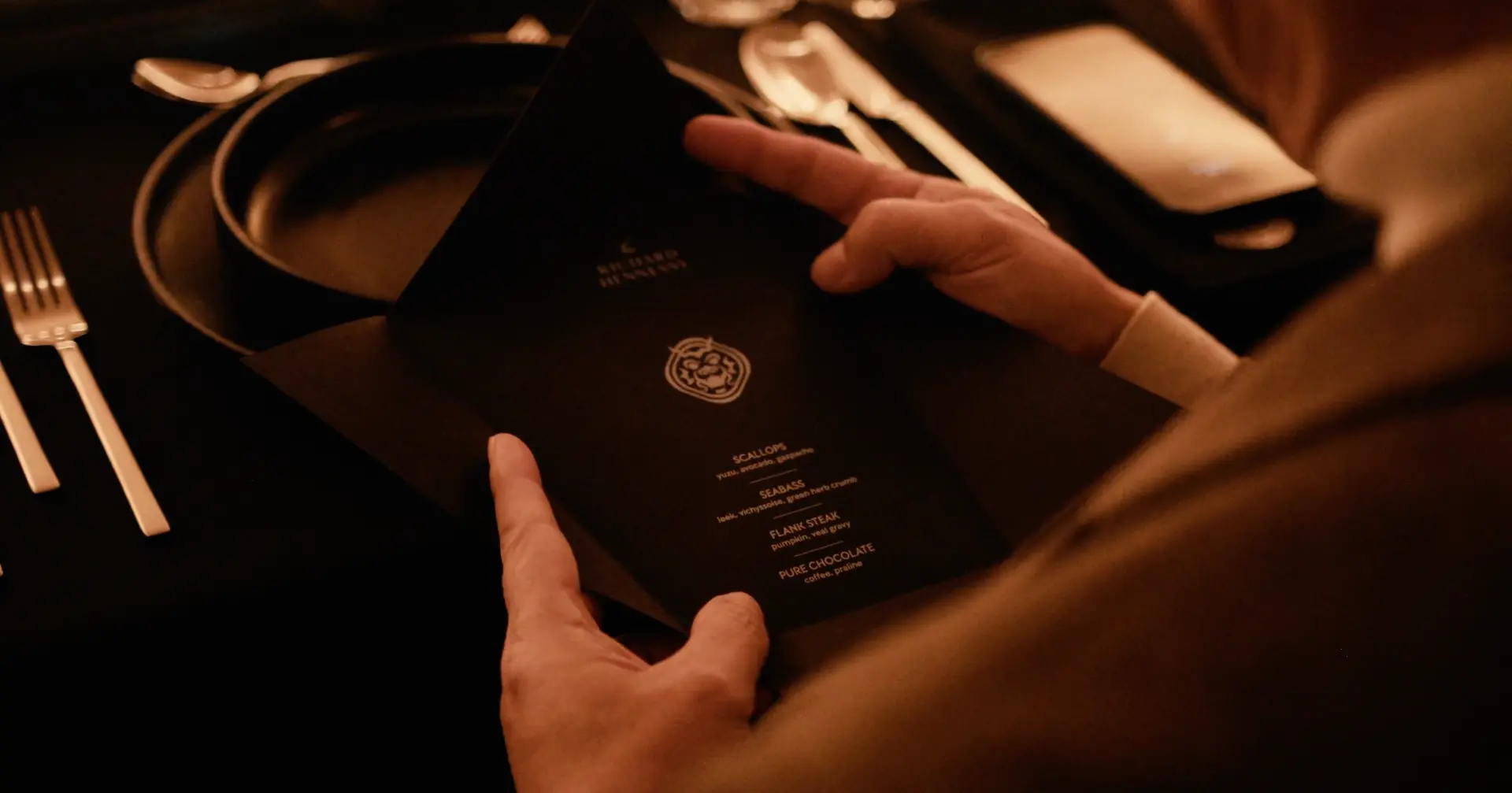 Guest reading the Richard Hennessy dinner menu