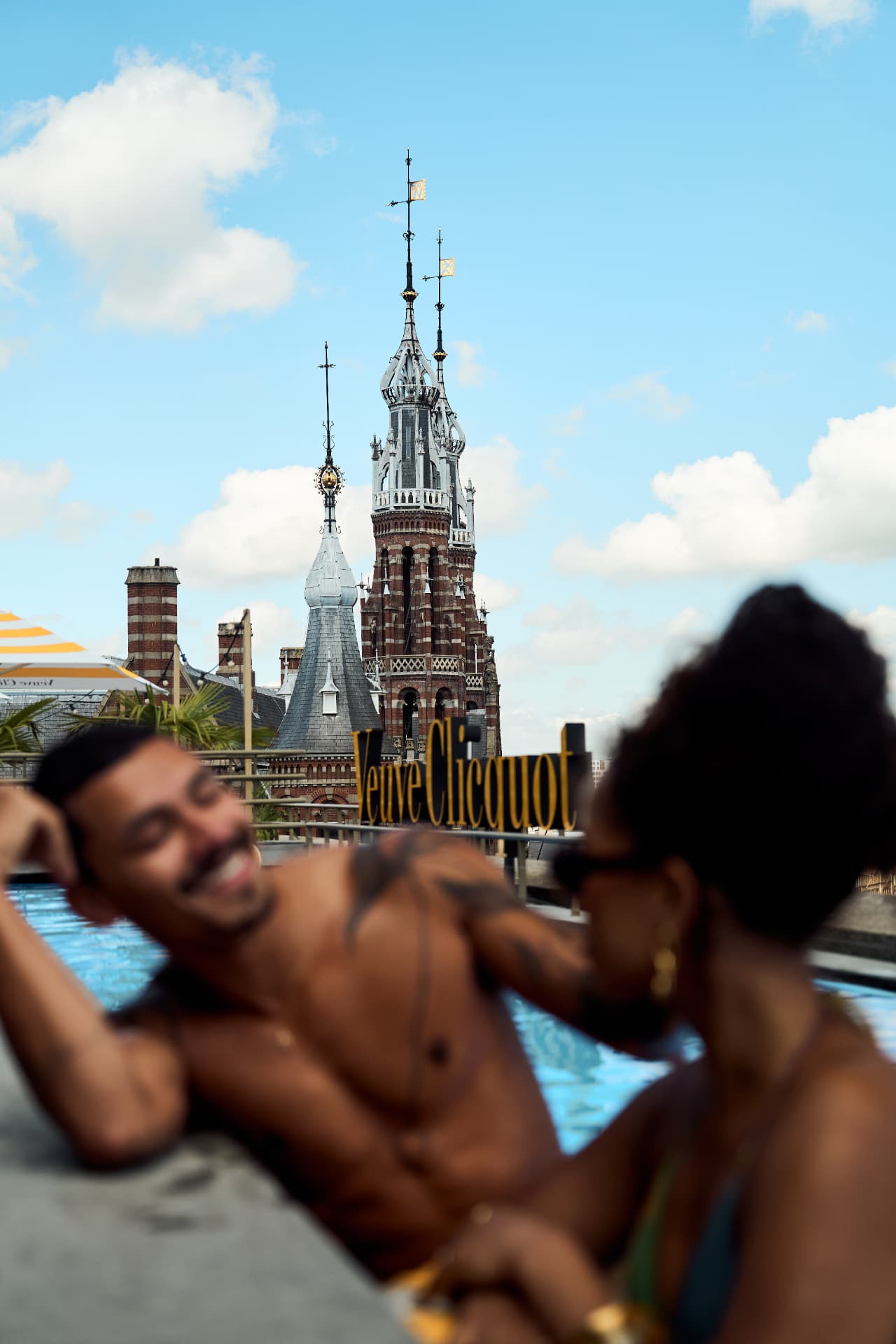 Pool and church tower behind the Veuve Clicquot sign