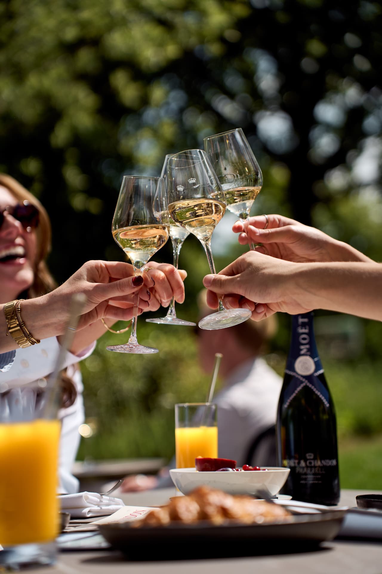 Three glasses meeting over the brunch table