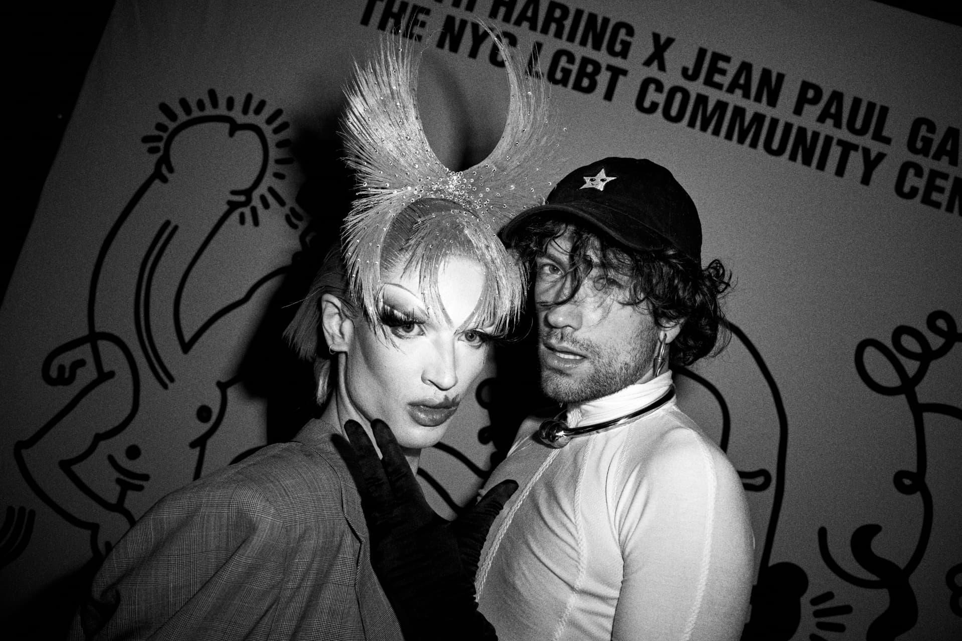Two guests posing at the Haring x Gaultier wall