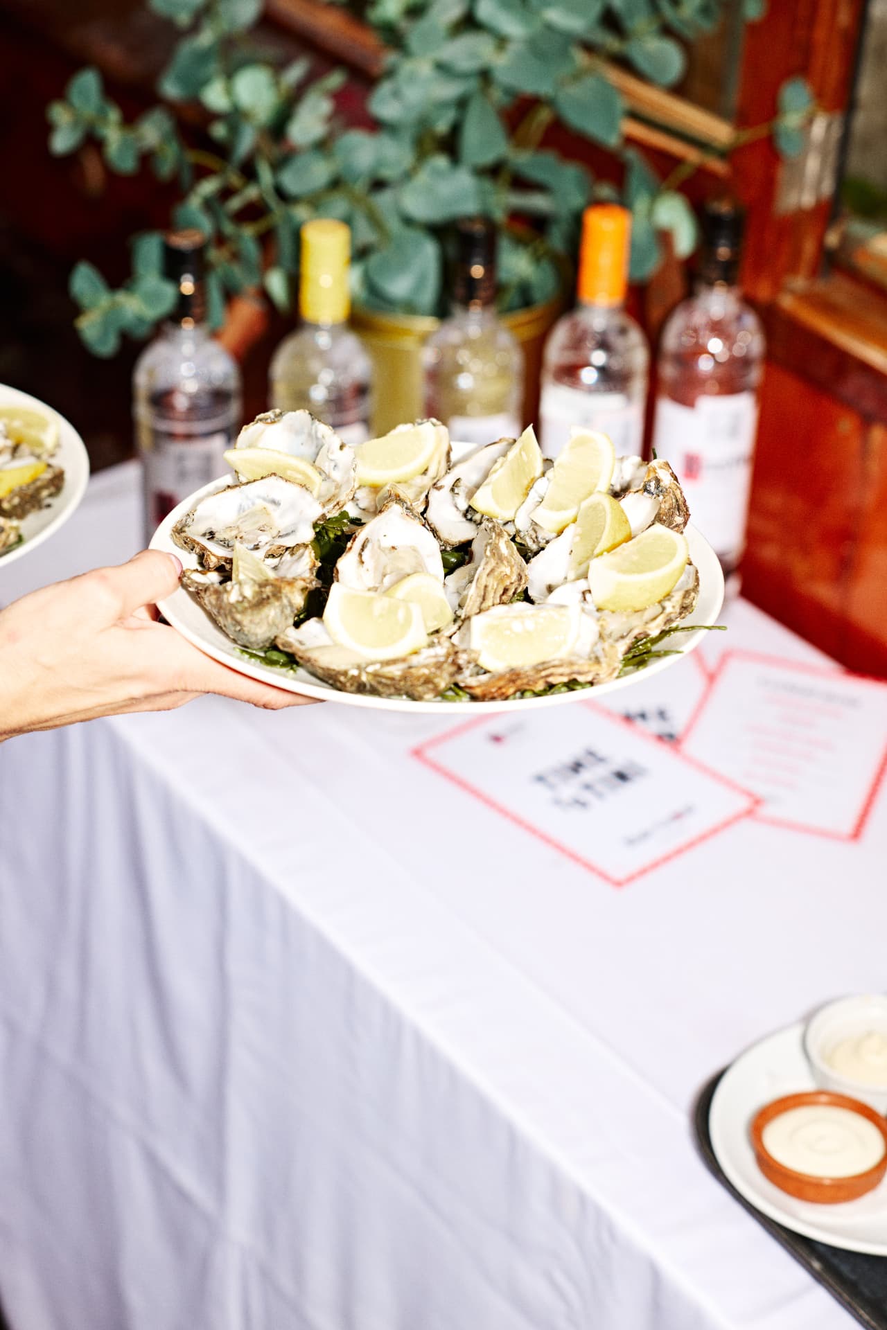 Ketel One bottles and oysters on a dressed table