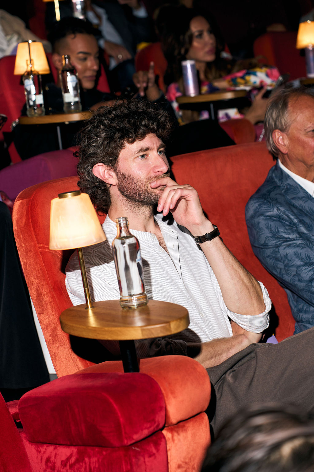 Guest watching the film from a red velvet cinema chair