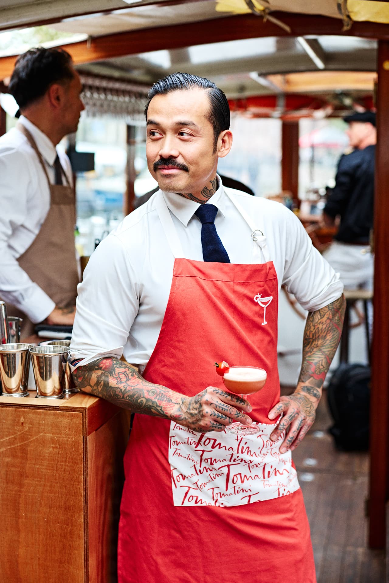 Bartender presenting a cocktail on board