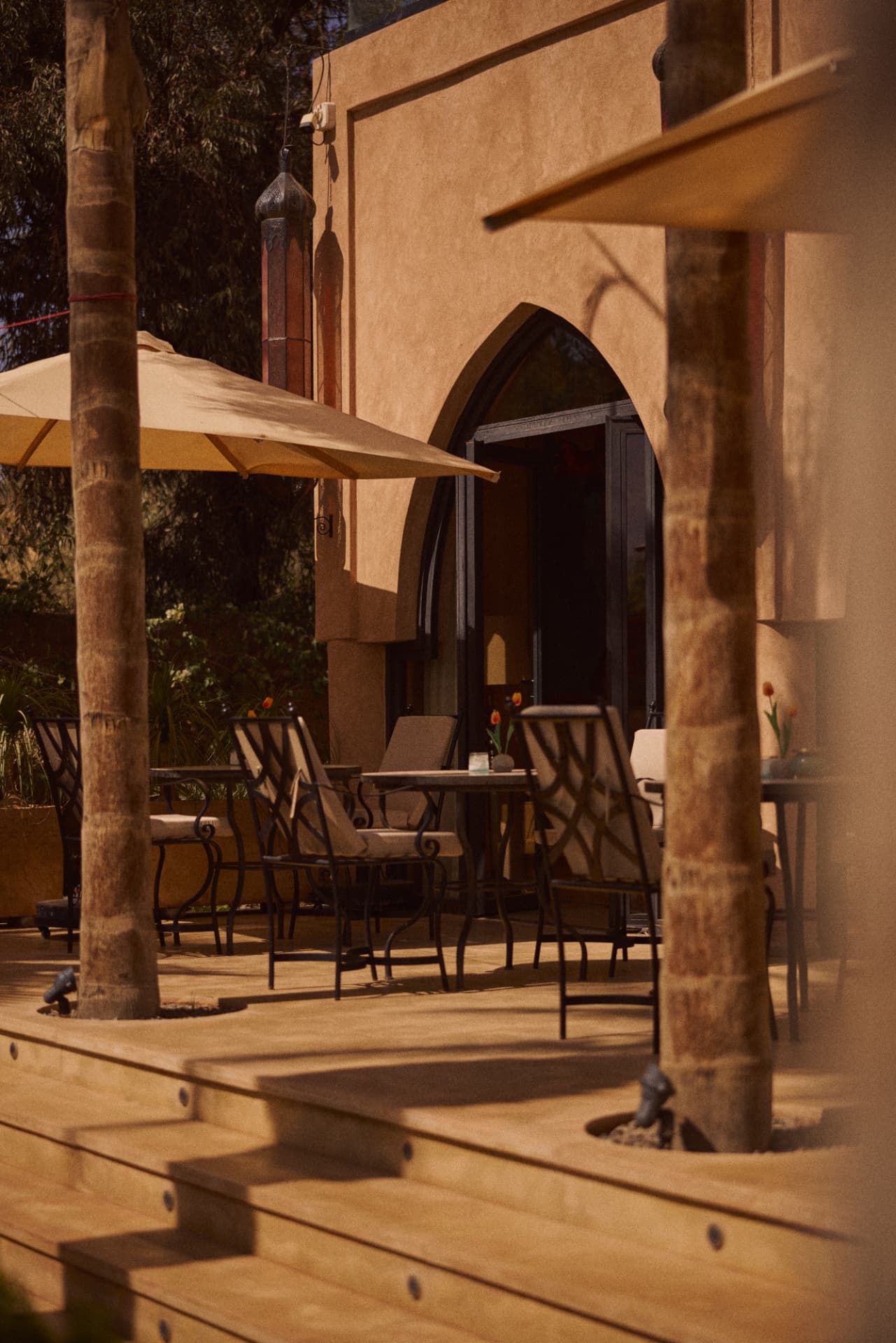 Arched doorway opening onto set terrace tables