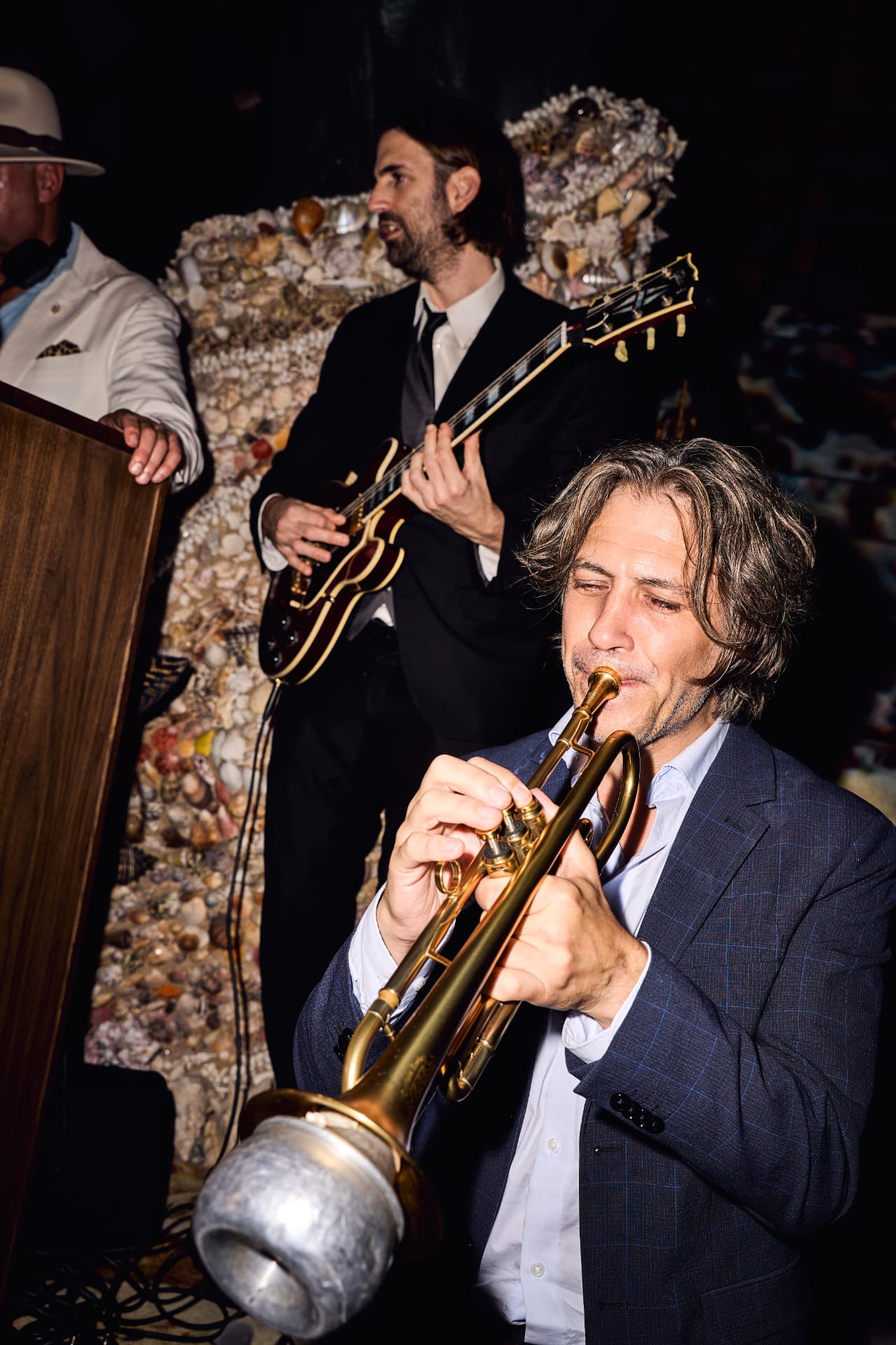 Trumpet player performing beside the shell wall