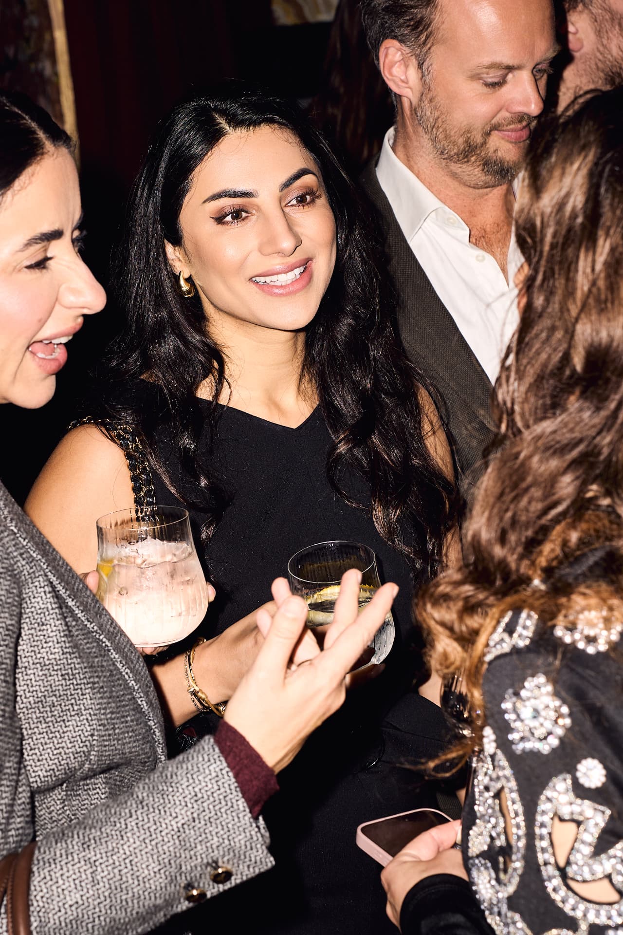 Guests laughing over drinks