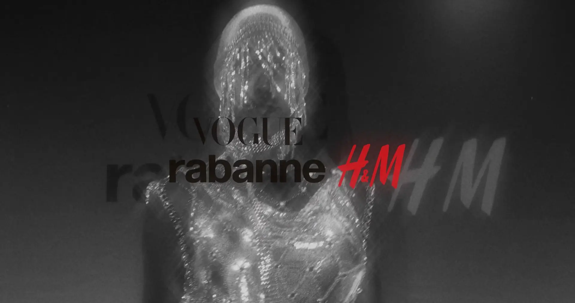 Vogue, Rabanne and H&M branding reflected beside a metallic figure