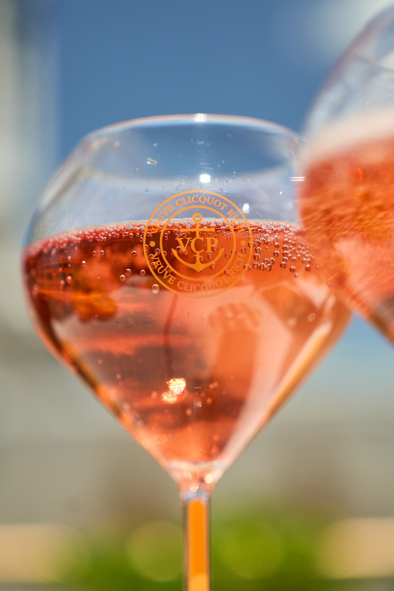 Macro of a Rich Rosé serve against blue sky