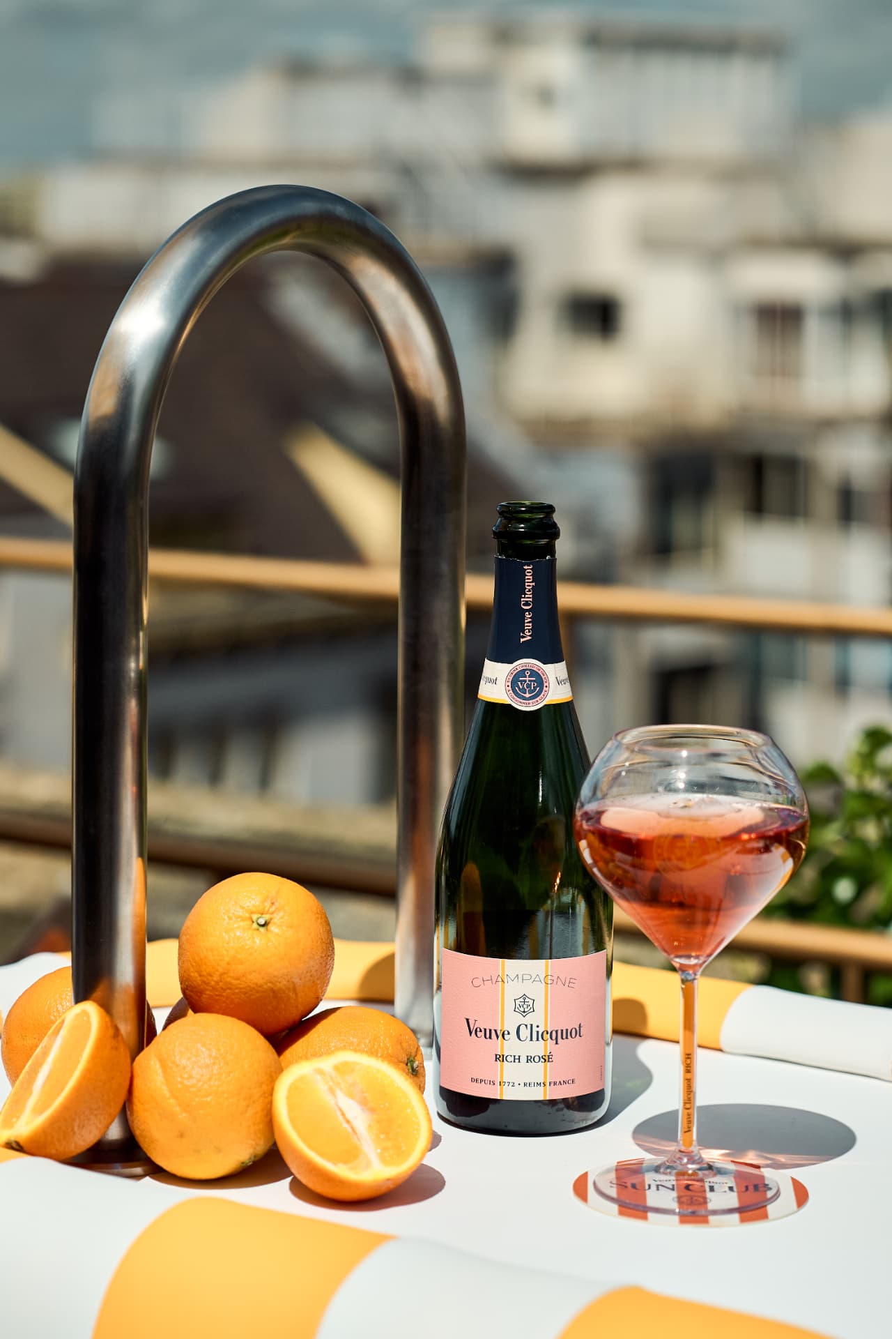 Rich Rosé and oranges beside the pool ladder