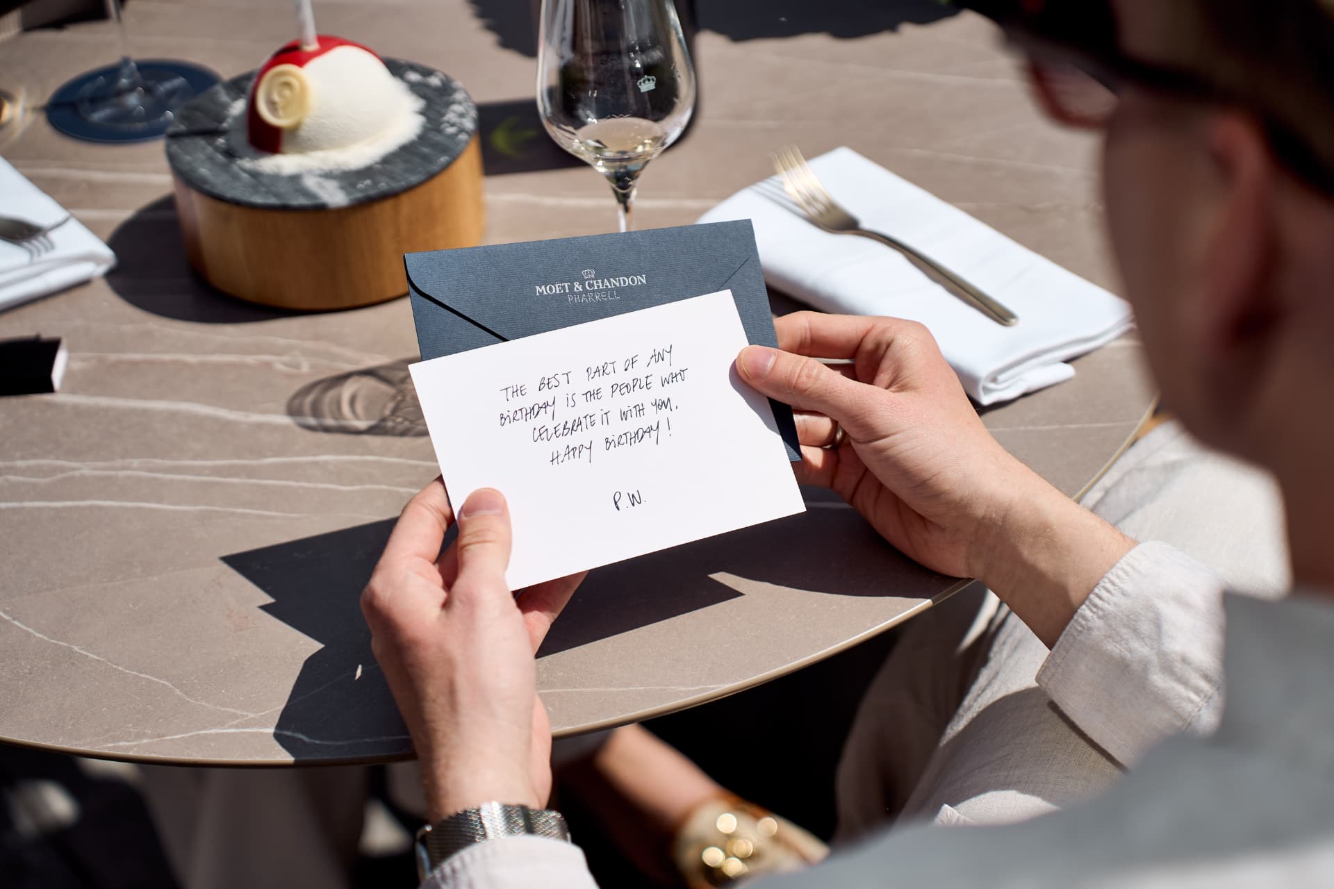 Guest reading a handwritten card from Pharrell