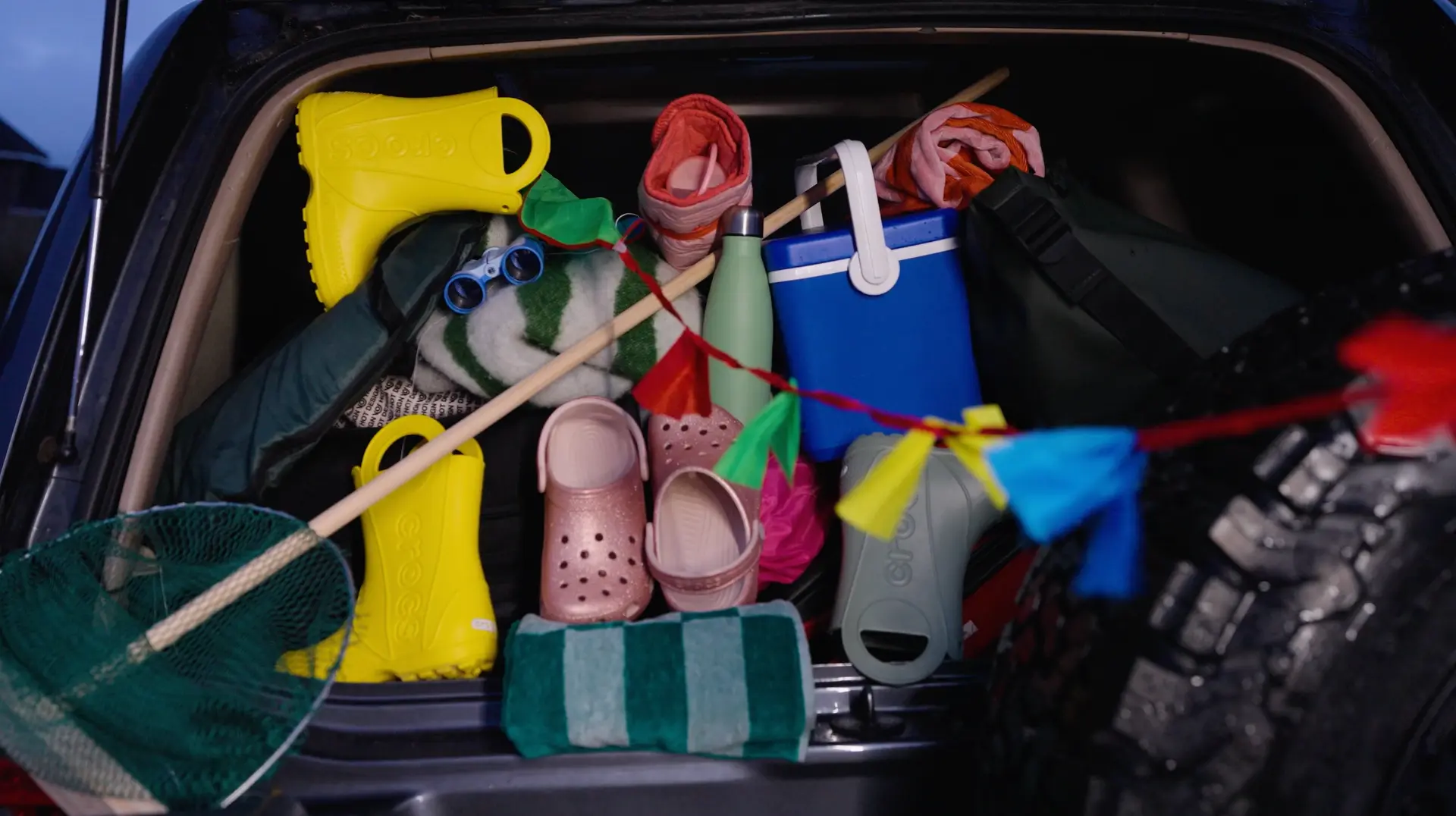 Packed car boot with beach gear and bunting