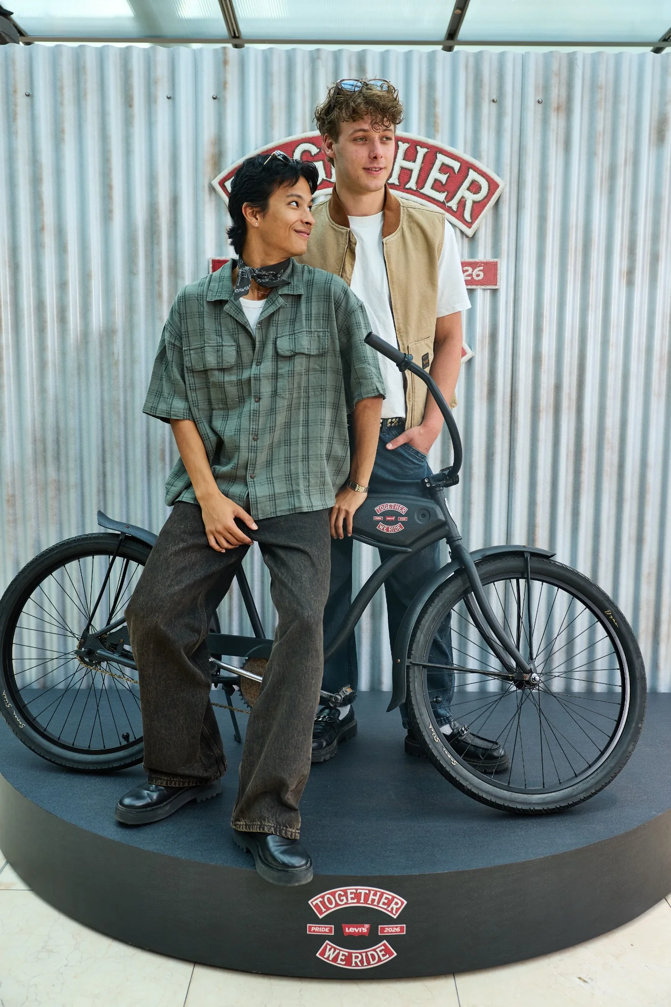 Two guests laughing by the bike on the Levi’s Together We Ride stage