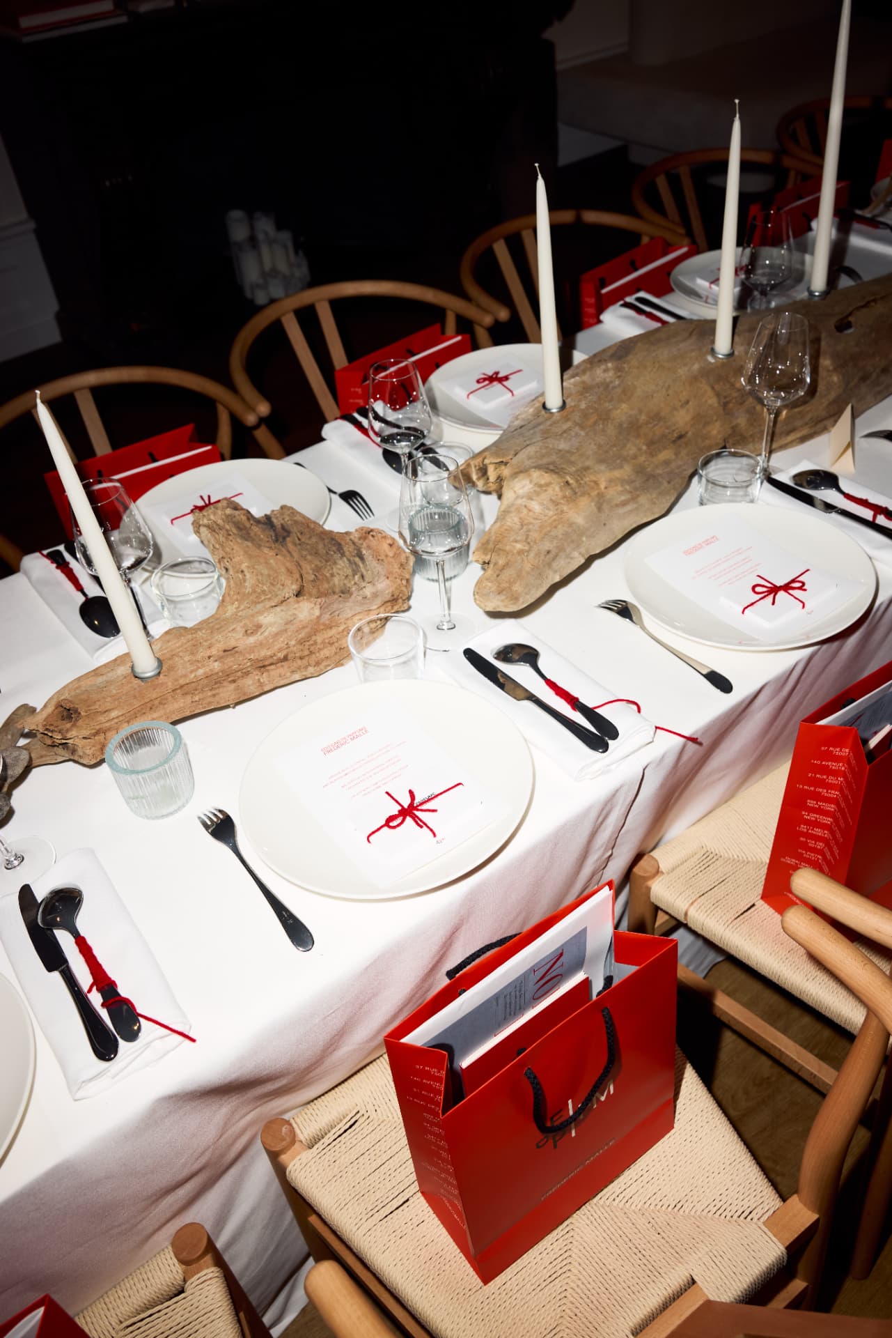 Dinner table set with driftwood, candles and red thread for the Northern Love launch