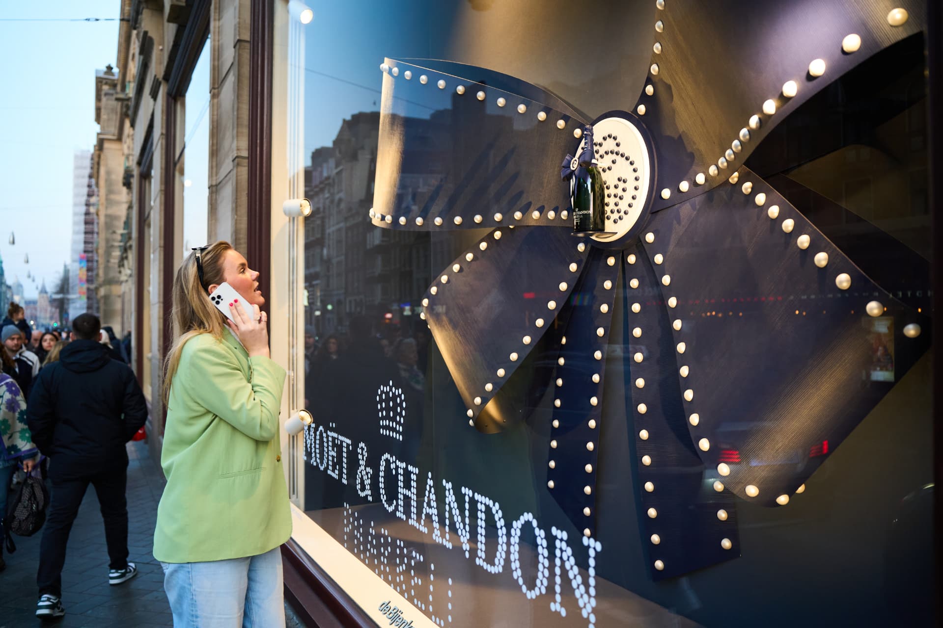Passer-by looking at the lit bow installation