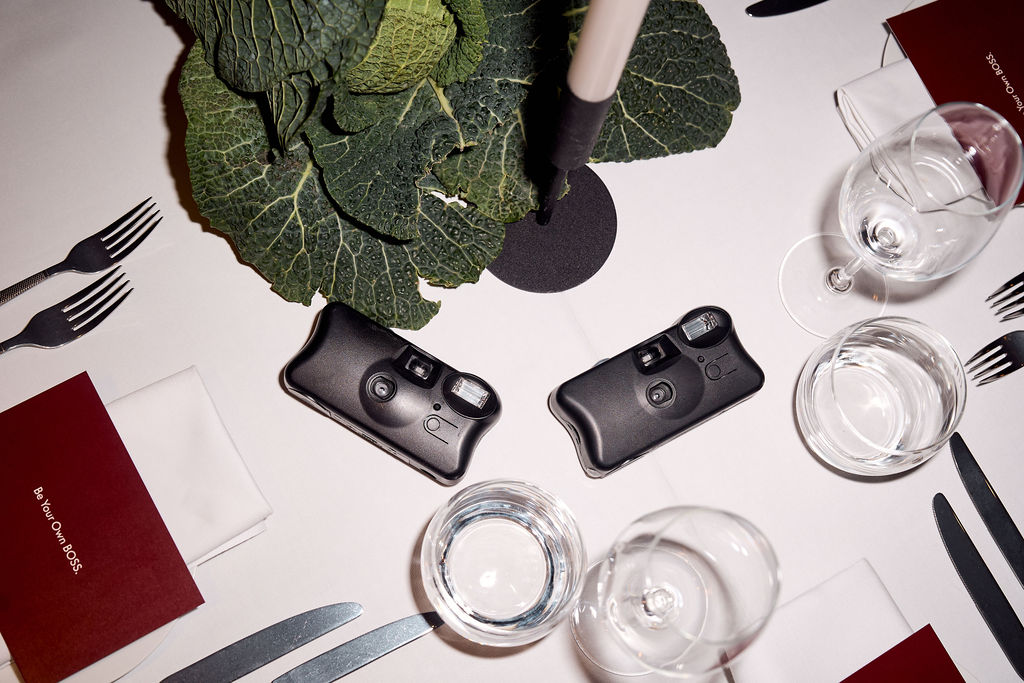 Table top with disposable cameras and menus