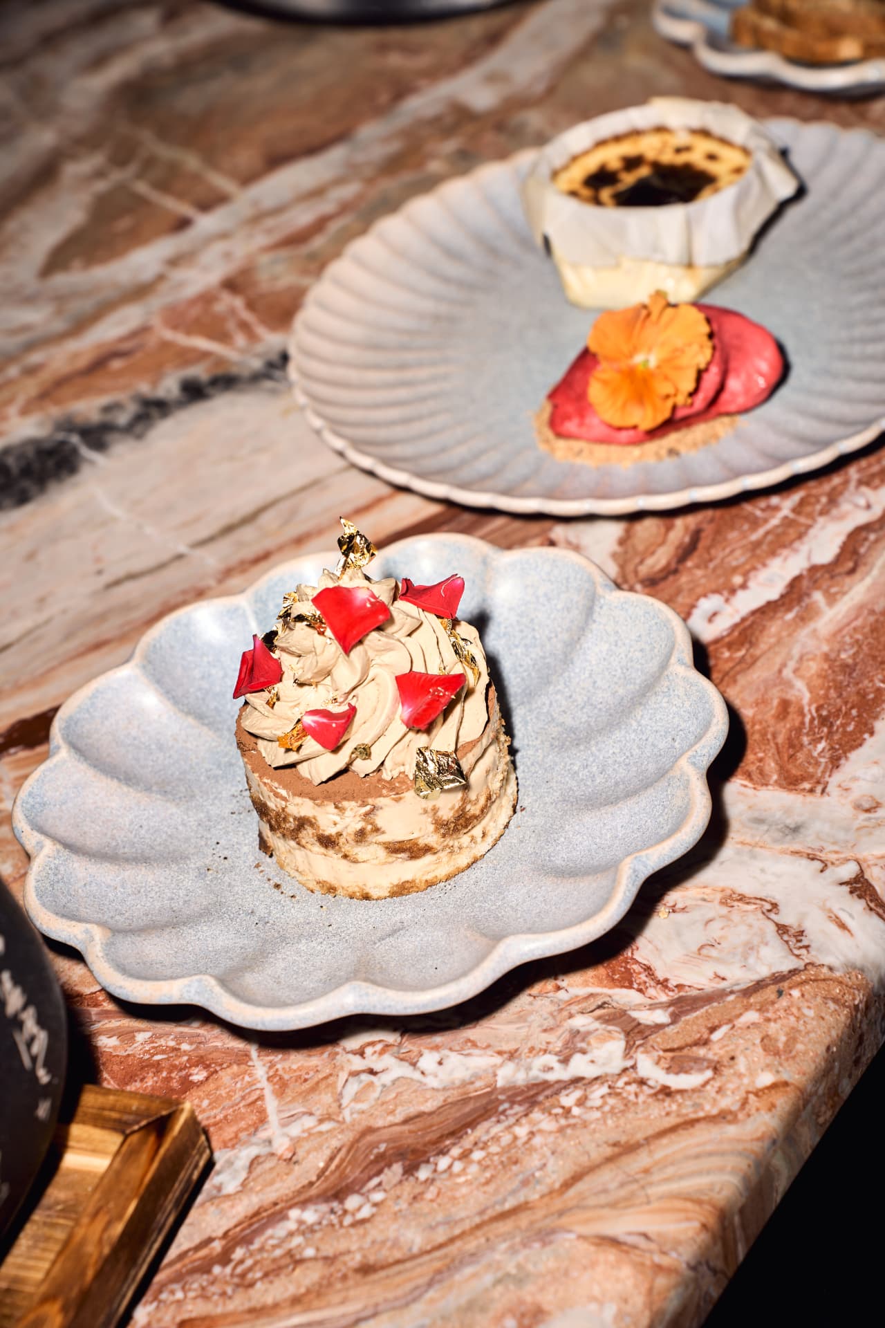 Dessert with gold leaf on a shell plate