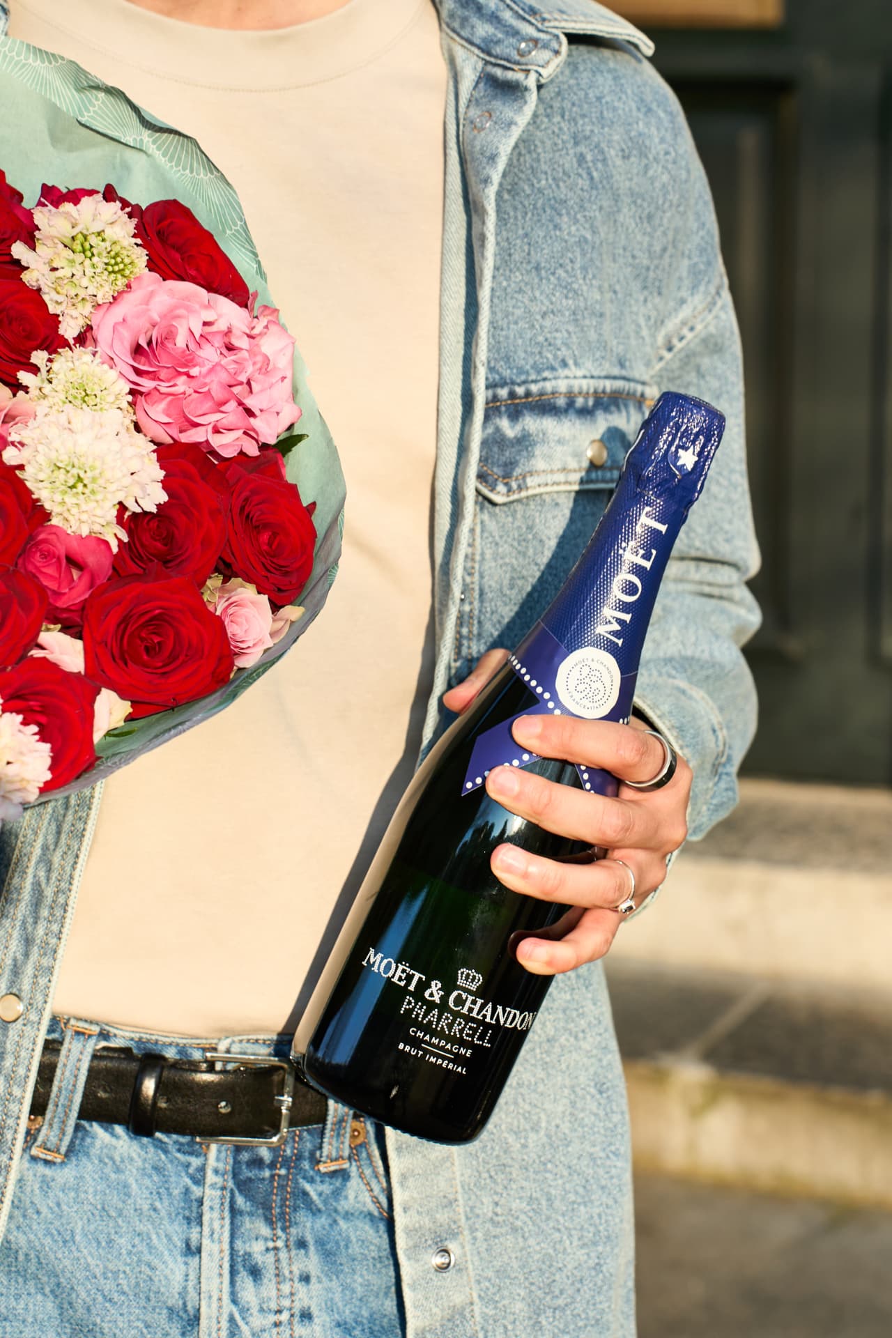 Courier holding flowers and the Pharrell bottle