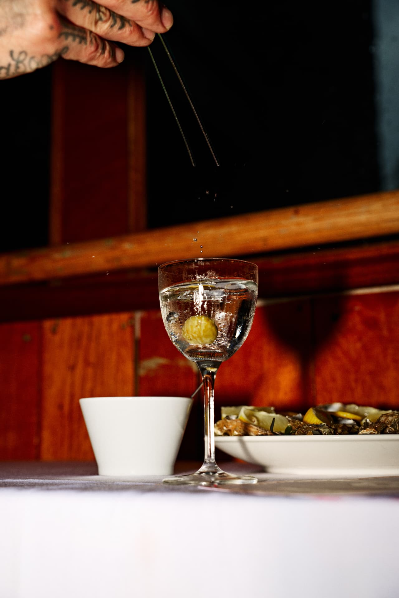 A cocktail being finished at the bar