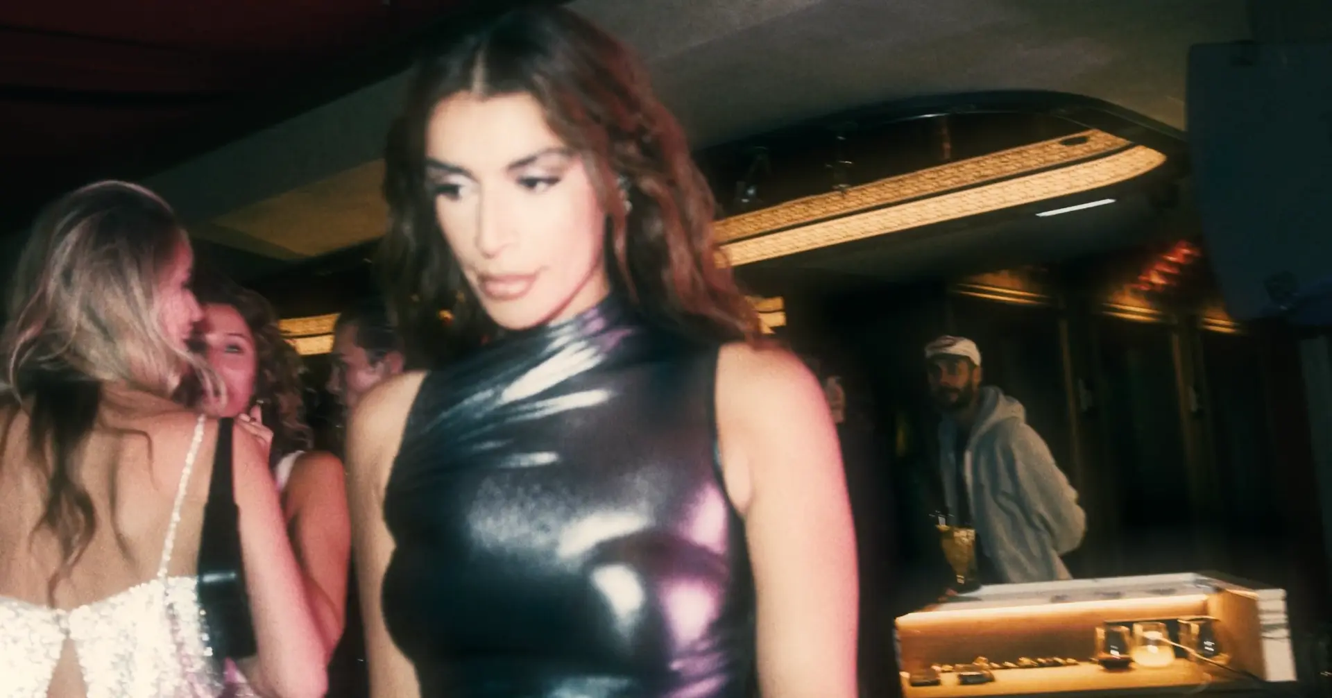 Guest wearing a sculptural metallic top