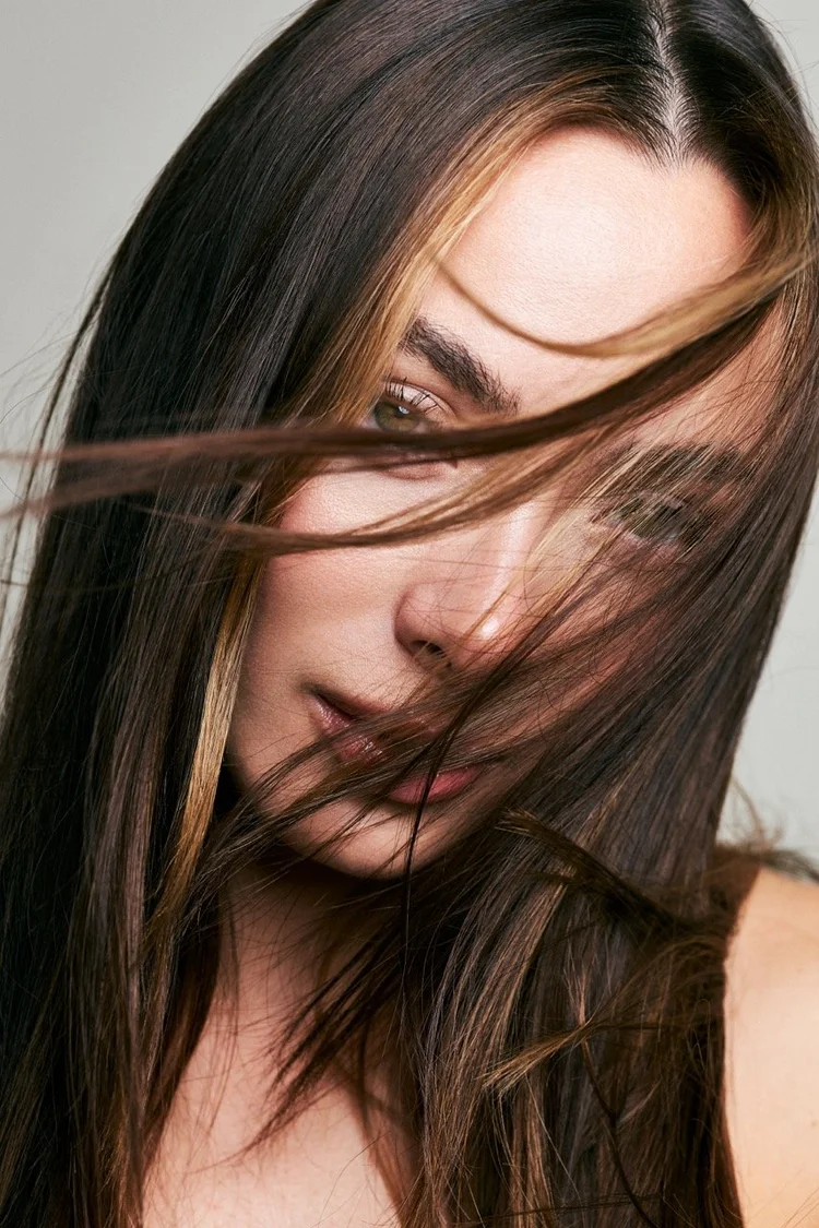 Beauty portrait with hair blown across the face
