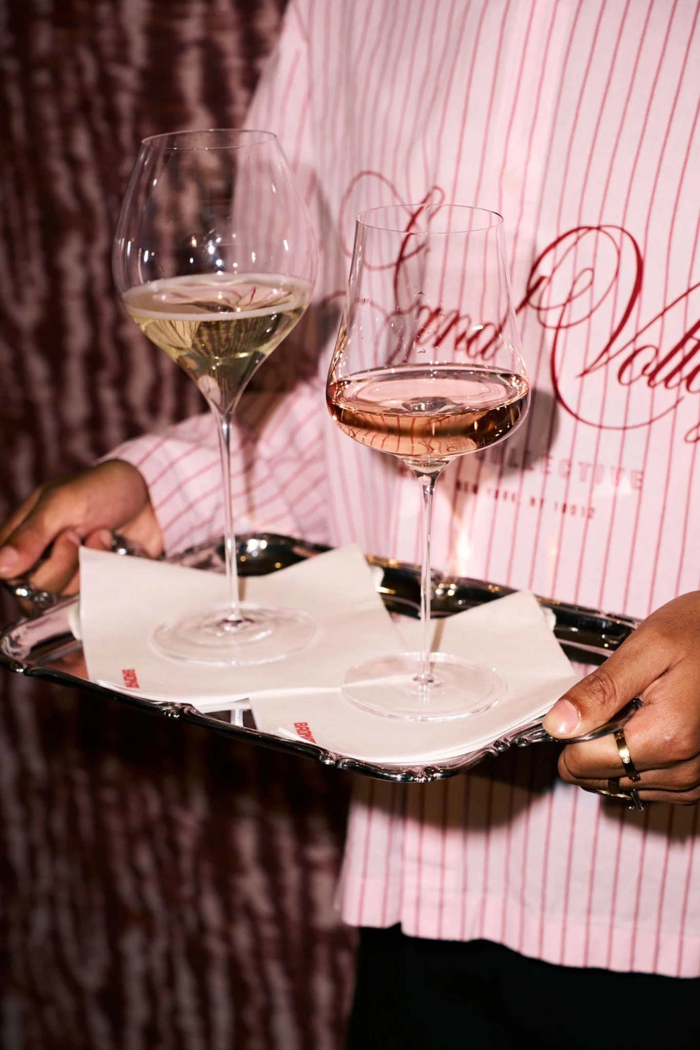 Wine glasses on a pink serving tray