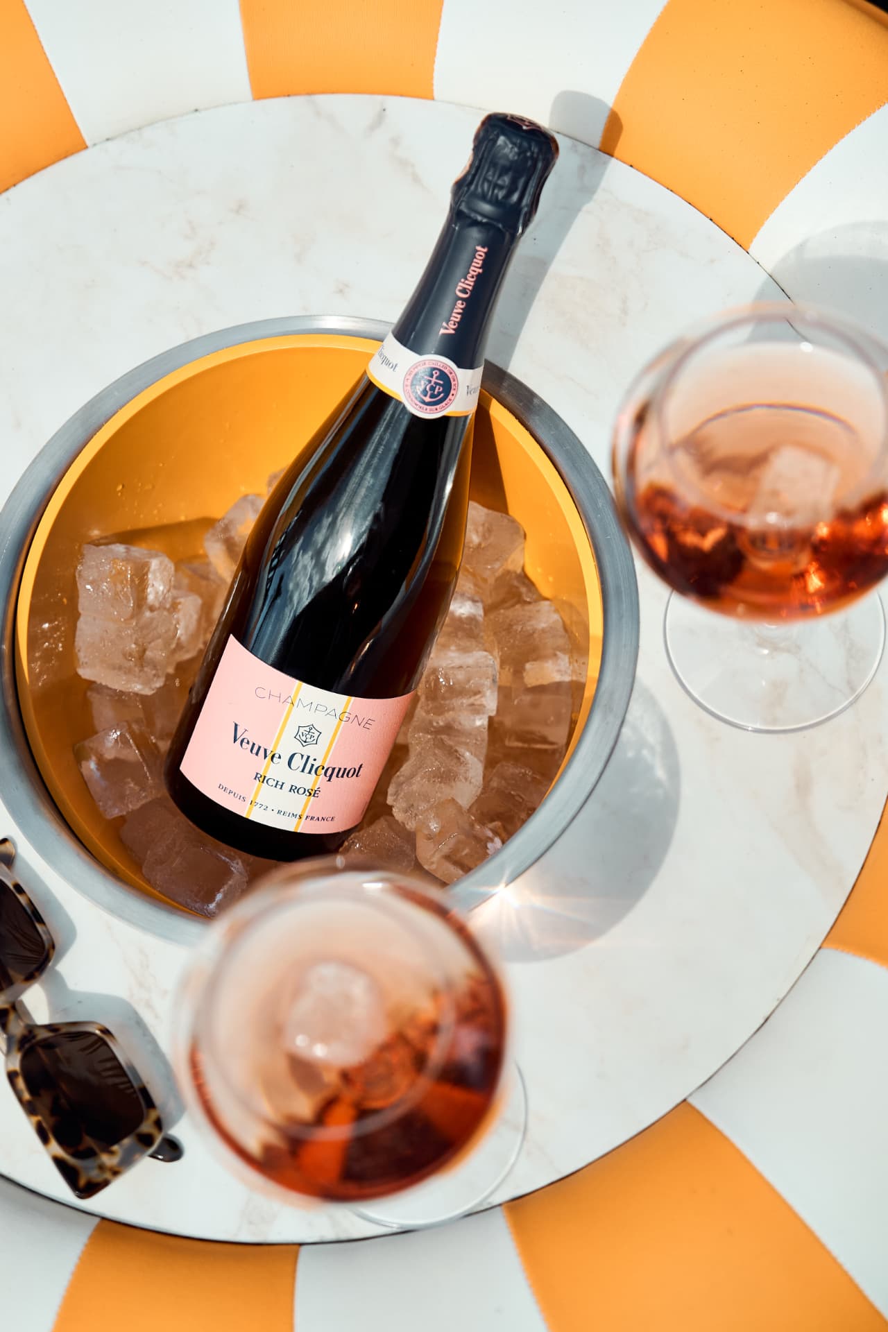 Veuve Clicquot Rich Rosé bottle in an ice bucket with two glasses