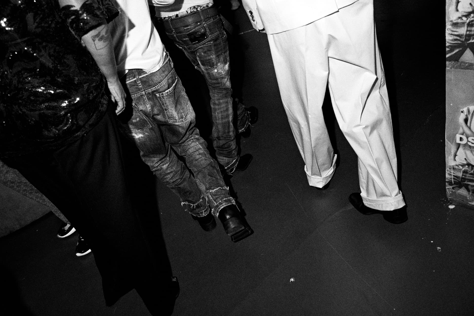 Legs and denim on the dancefloor, shot from above in black and white