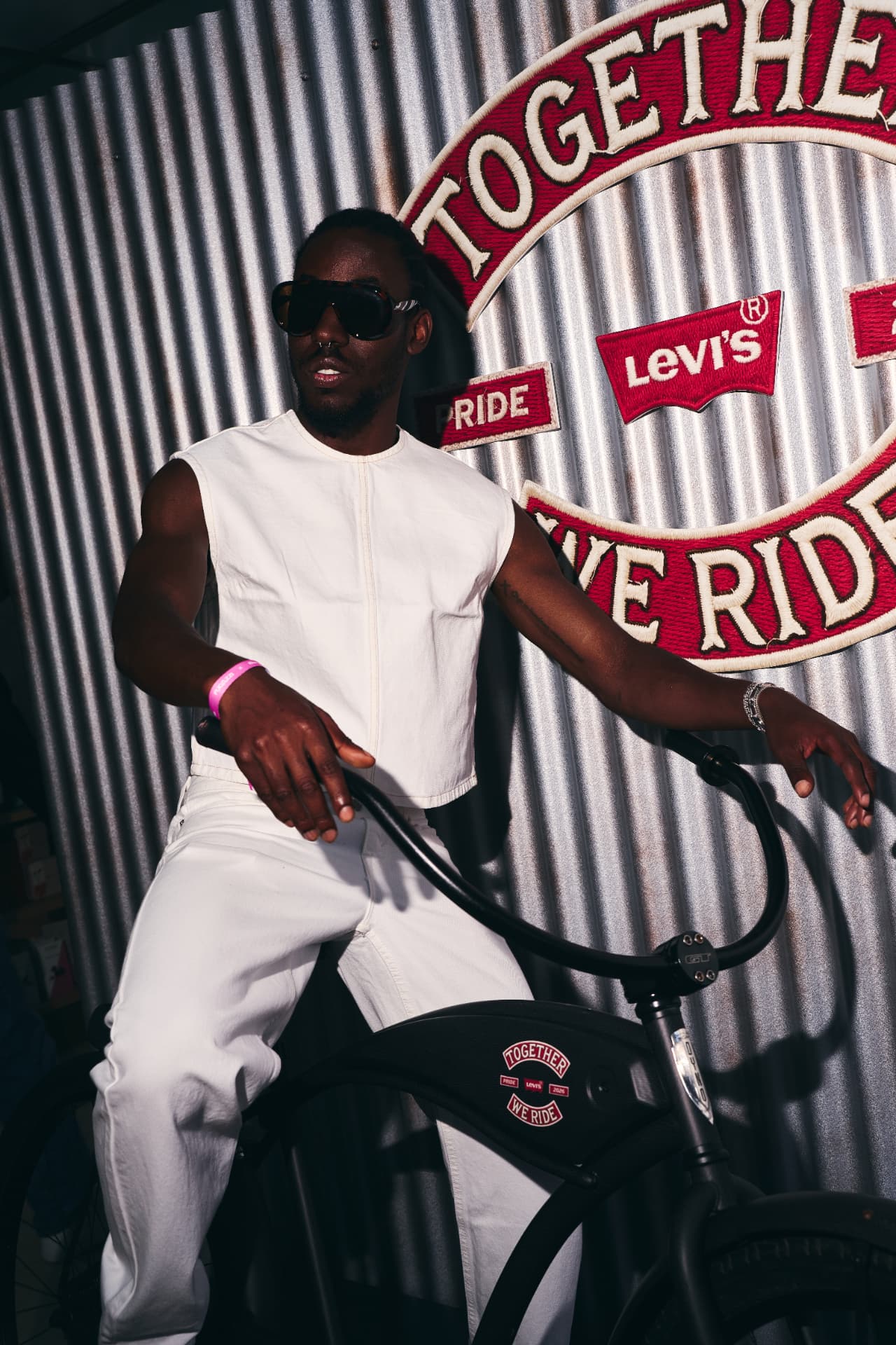 Guest in white denim on the Levi's bike in front of the patch wall