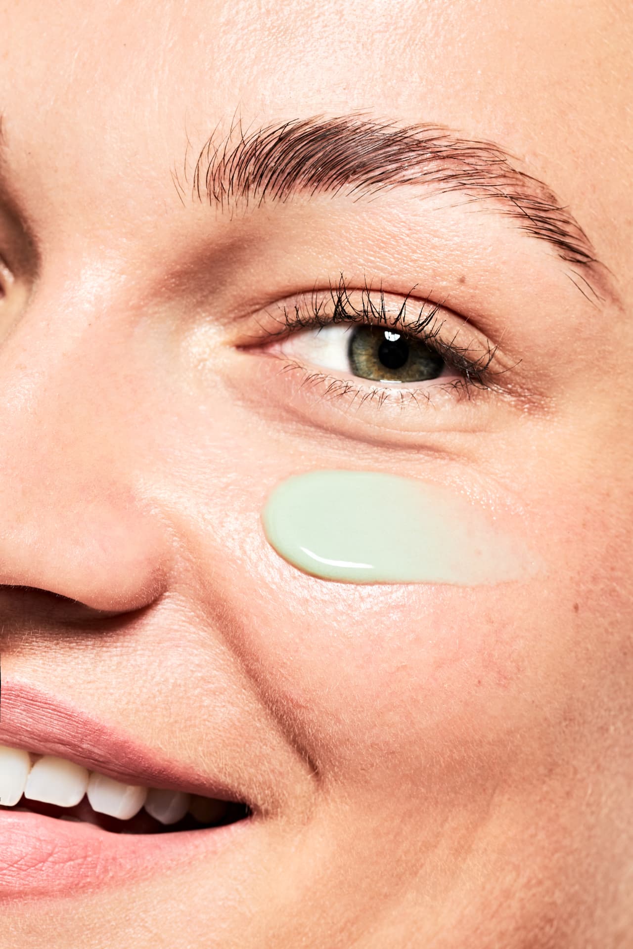 Macro of the green cream on the cheekbone