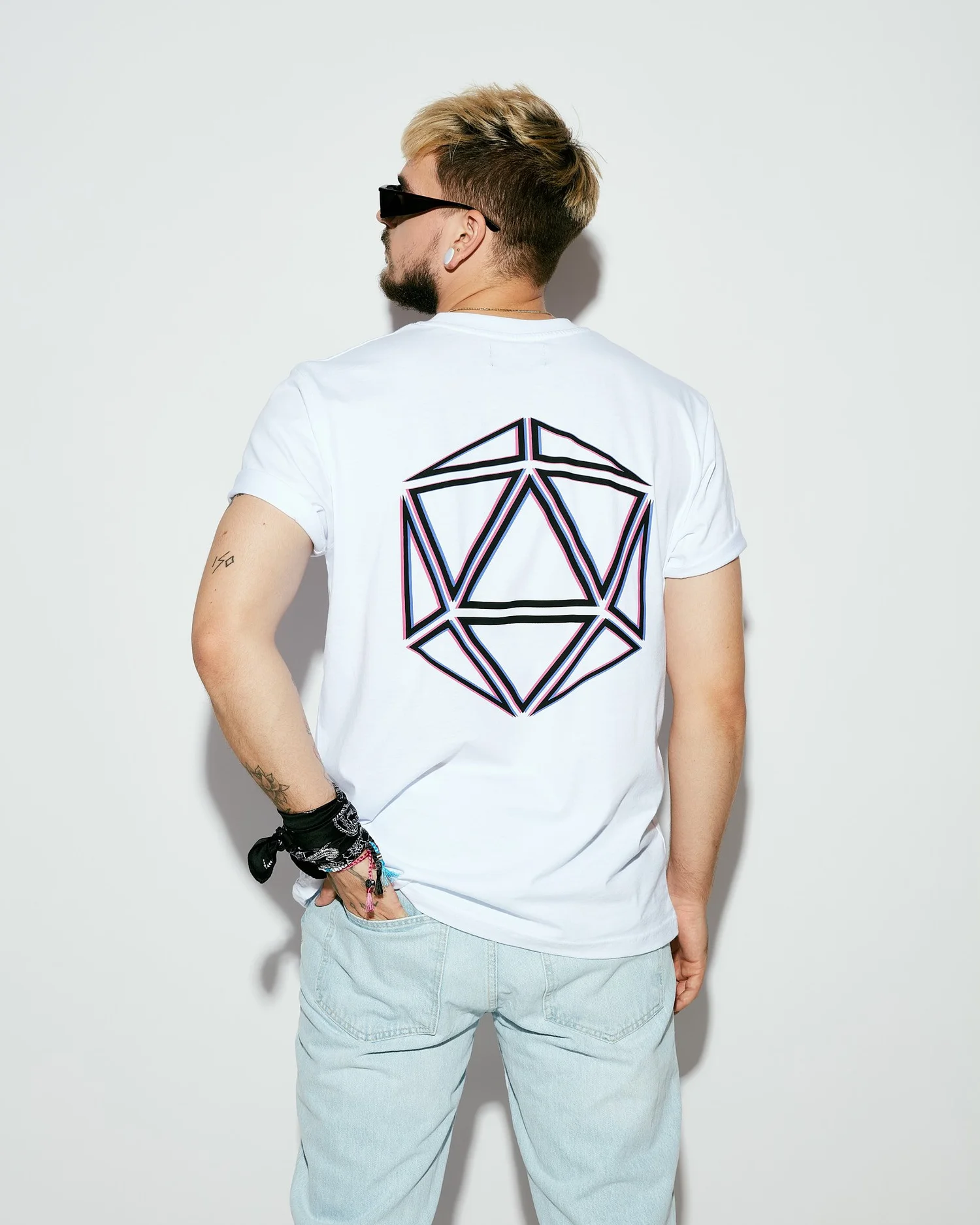 Back view of a white tee with the SAGA icosahedron print