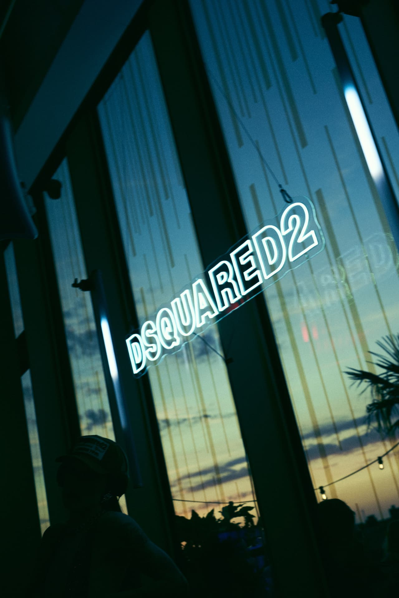 DSQUARED2 neon sign against the sunset through the glass façade