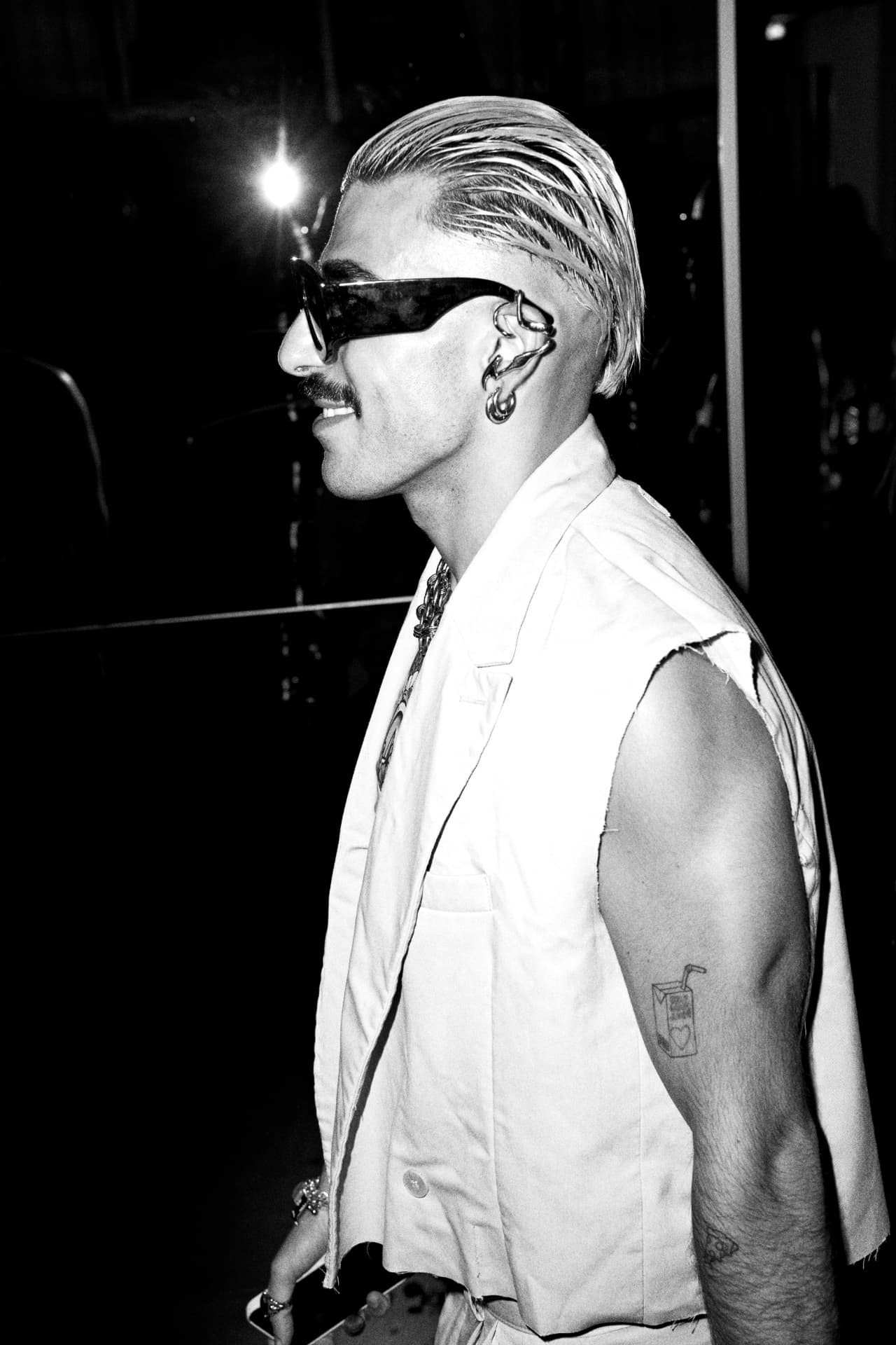 Black and white profile of a guest in sunglasses and earrings