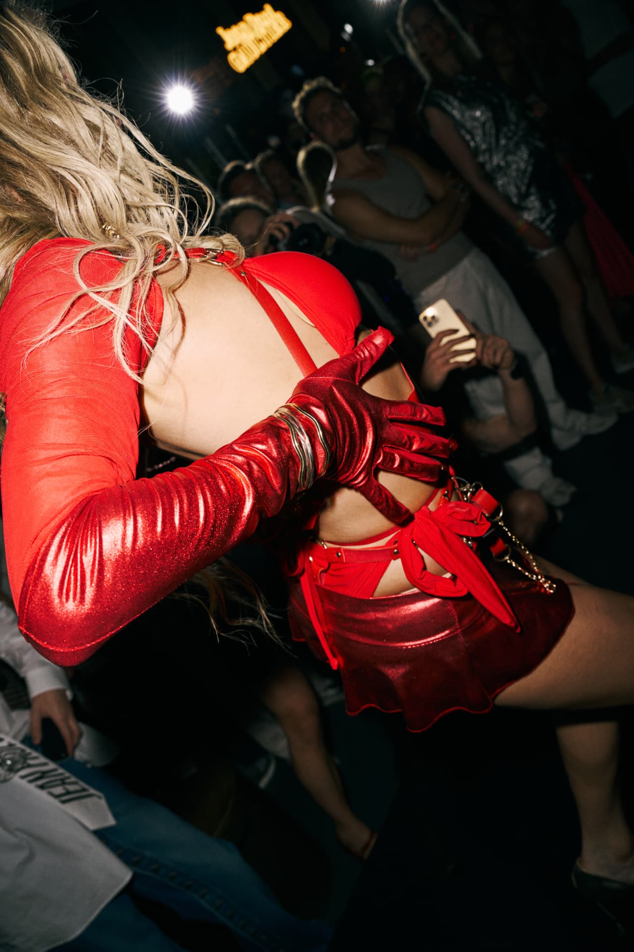 Performer in red gloves and metallic skirt on the floor