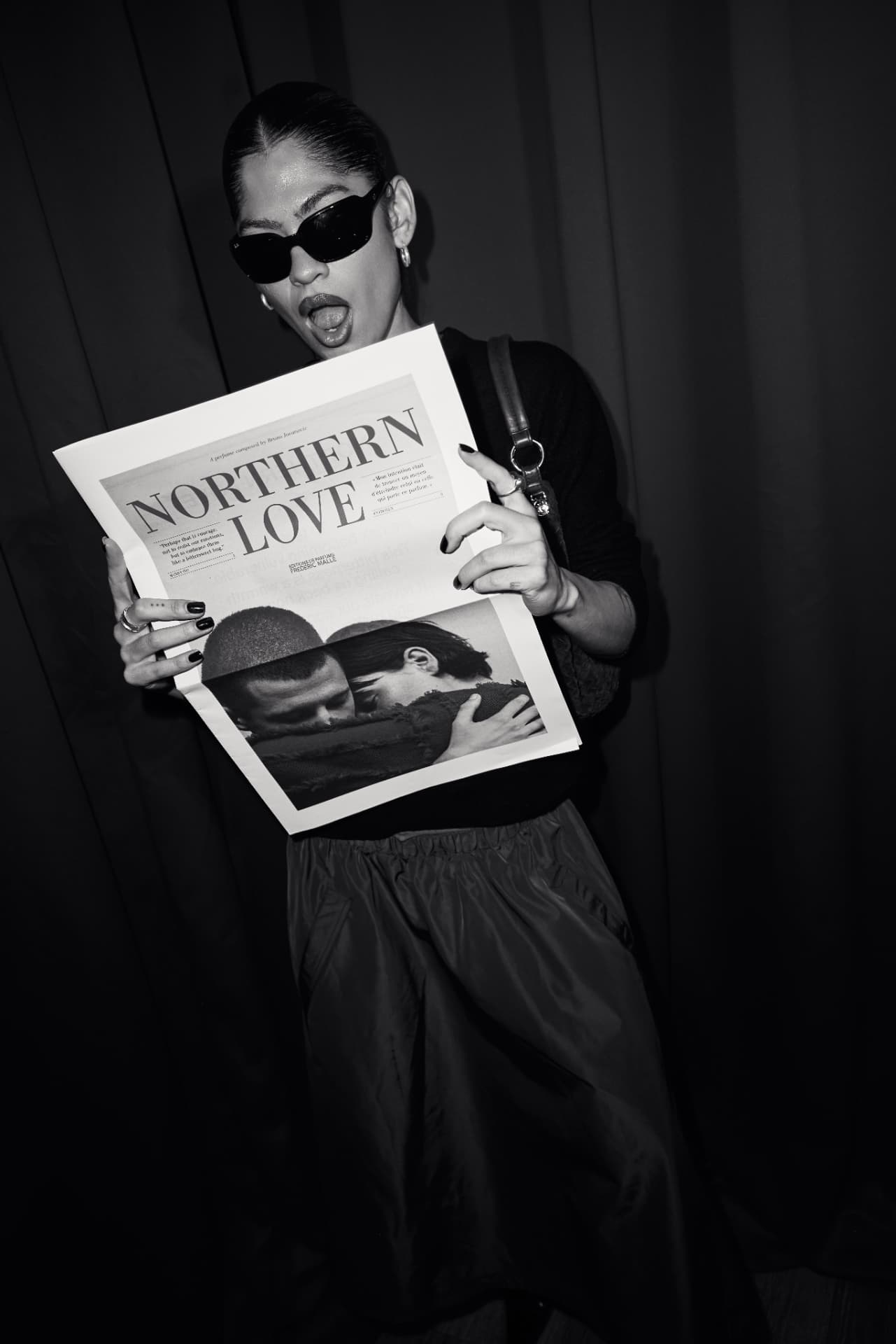 Black and white image of a guest reading the Northern Love newspaper