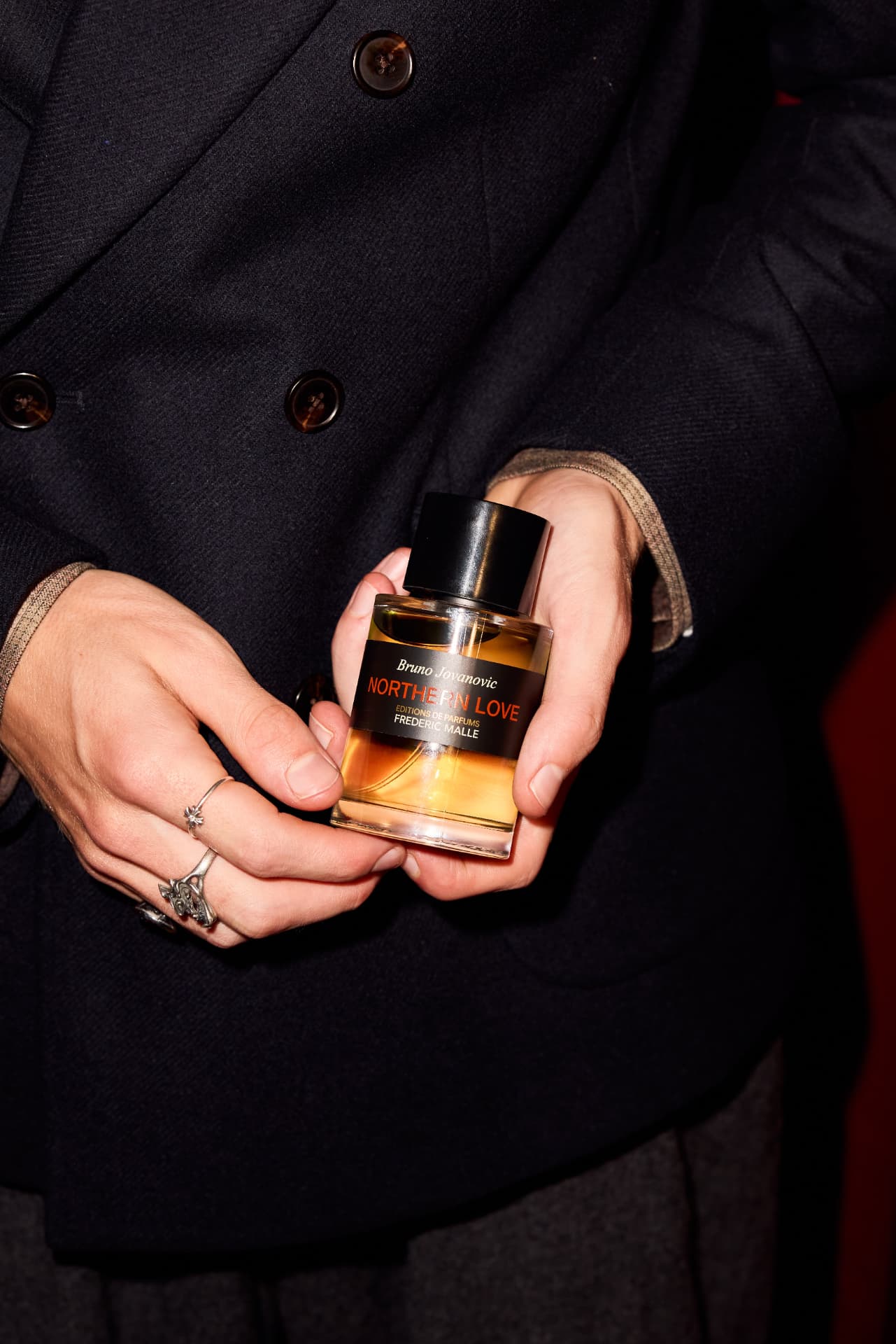 Ringed hands cradling a bottle of Northern Love