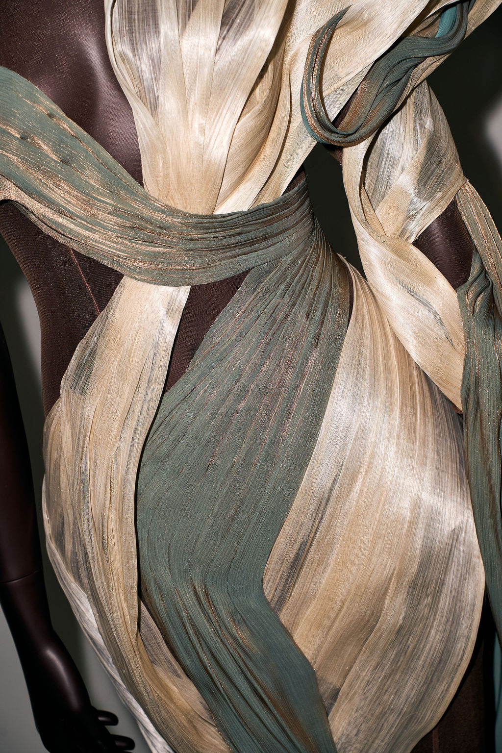 Pleated silk in sand and sage twisting around the body