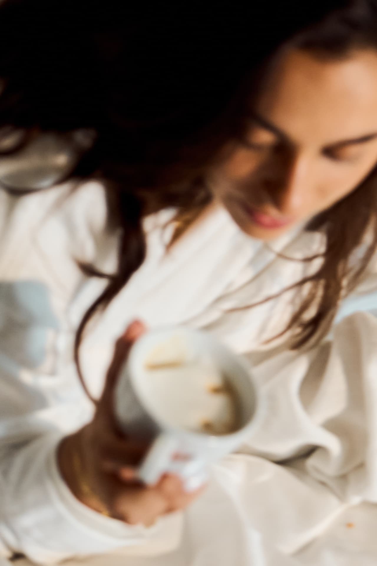 Soft frame of a guest with coffee in a robe