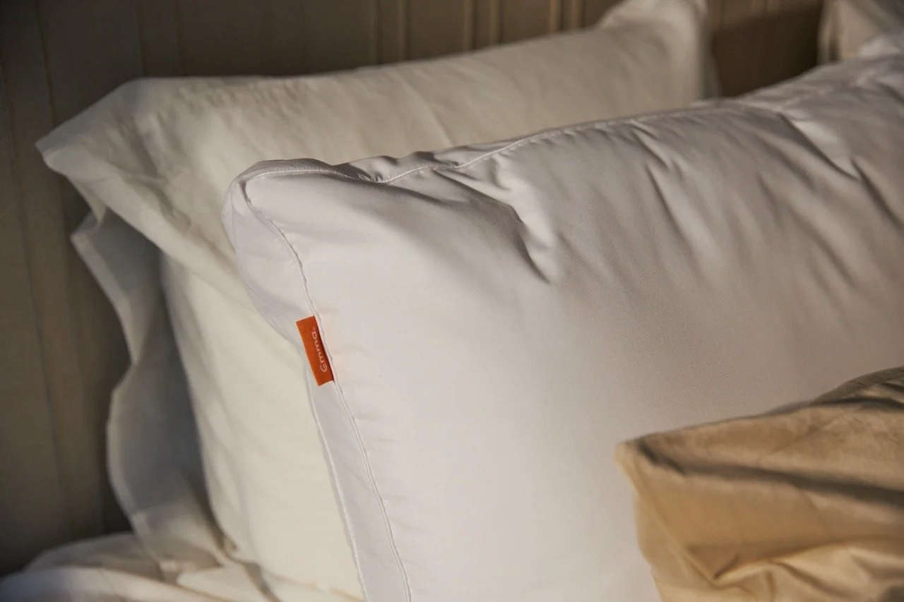 Close-up of a white Emma pillow with the orange label