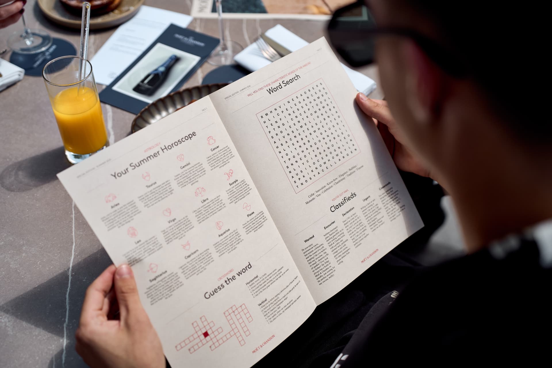 Guest solving the word search over orange juice