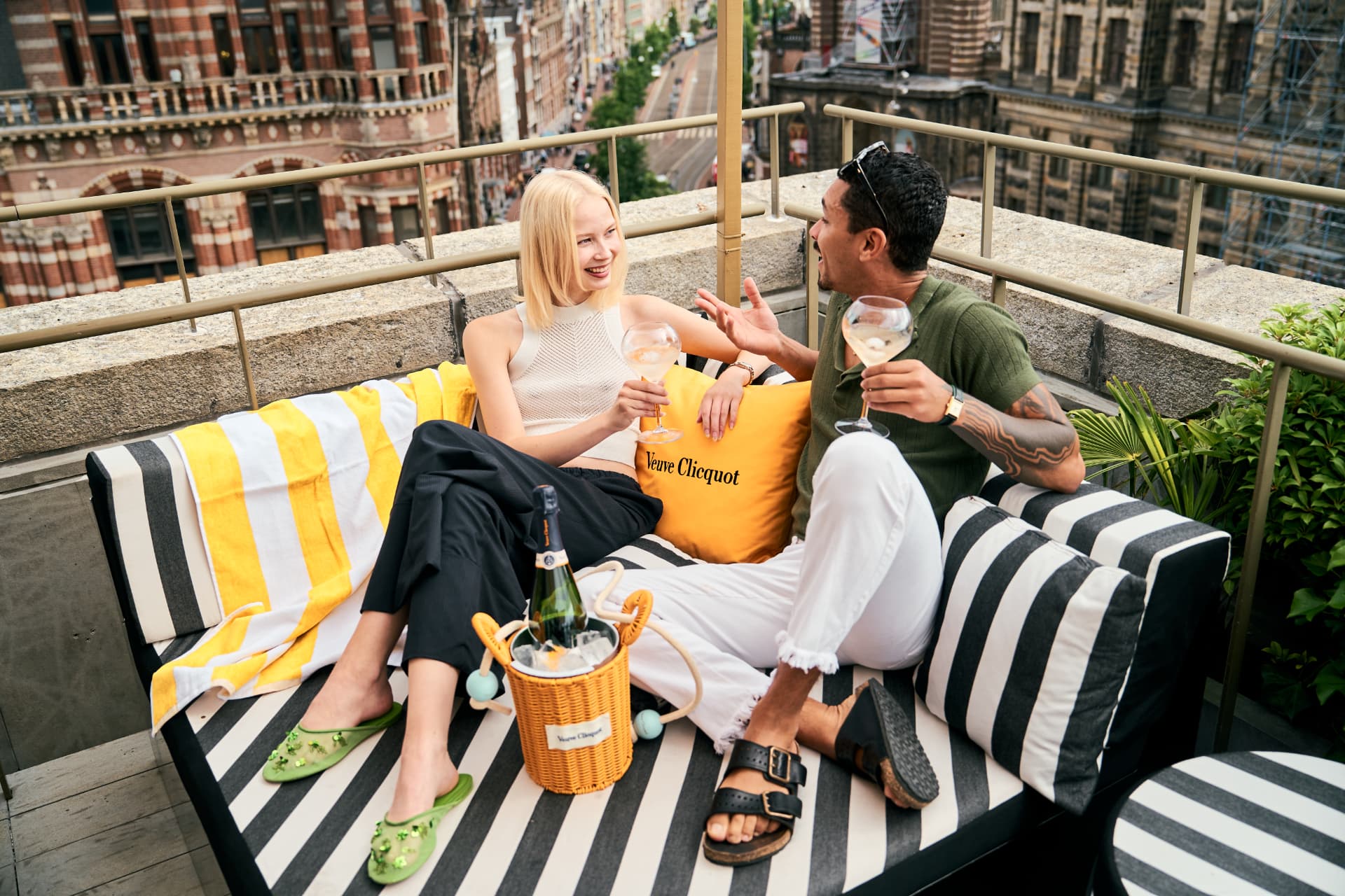 Couple on a striped daybed with champagne