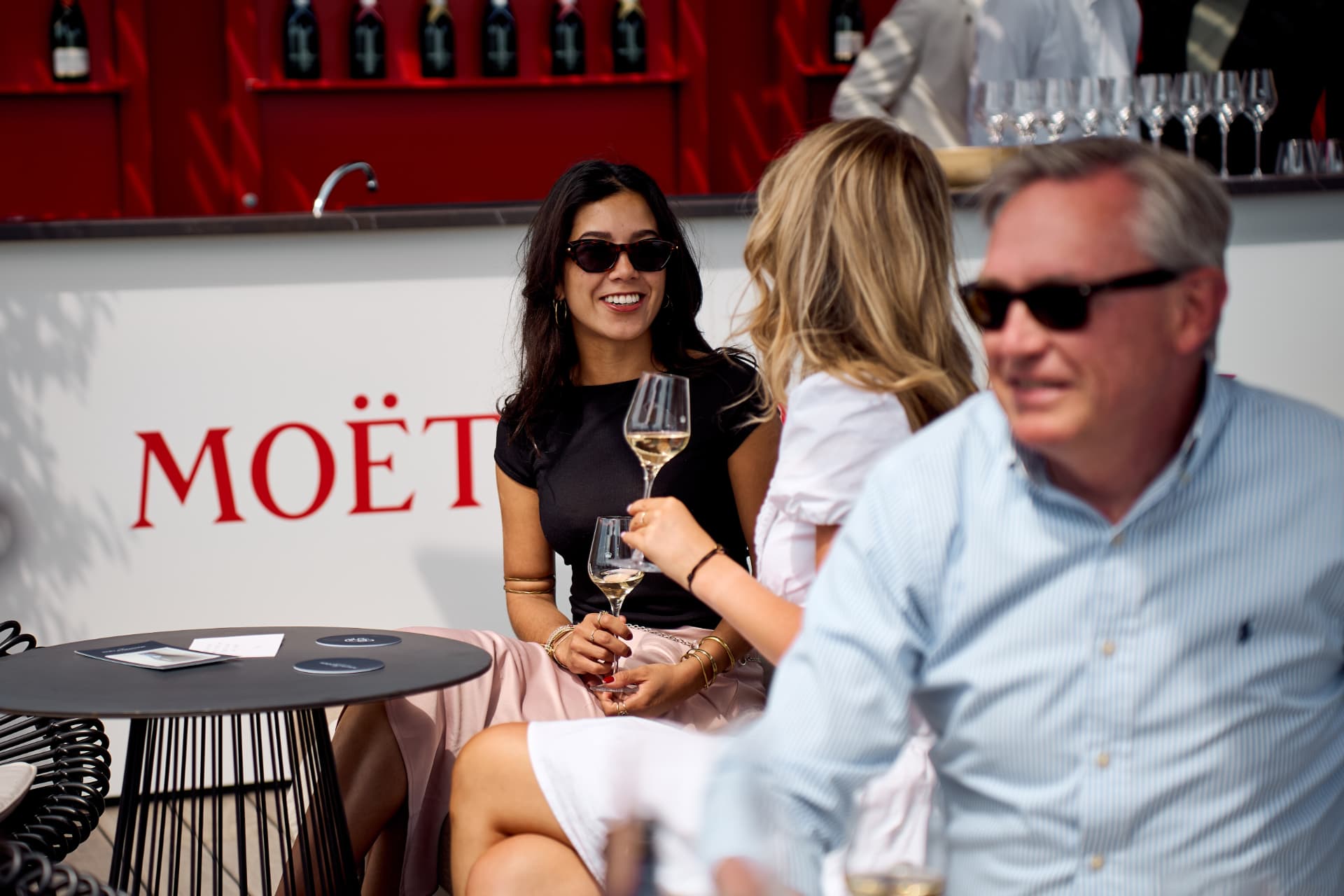 Guests talking in front of the Moët wall